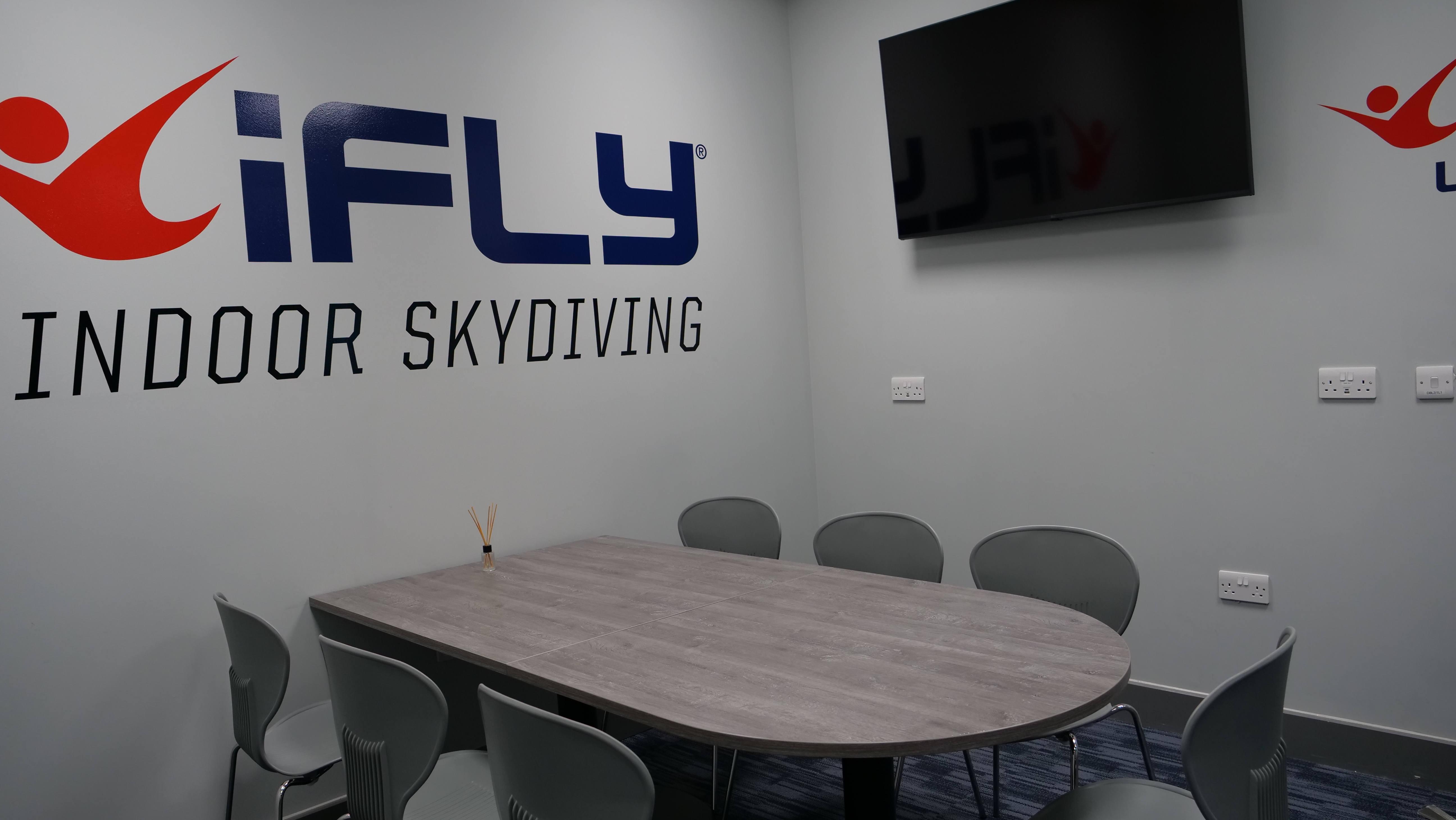 Modern meeting room at iFLY Indoor Skydiving, ideal for team-building events.