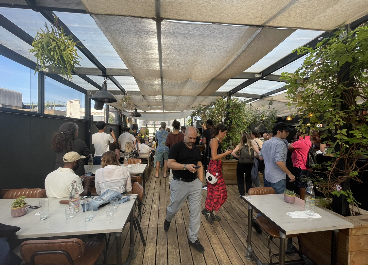 Vibrant rooftop venue with greenery, ideal for networking events and gatherings.