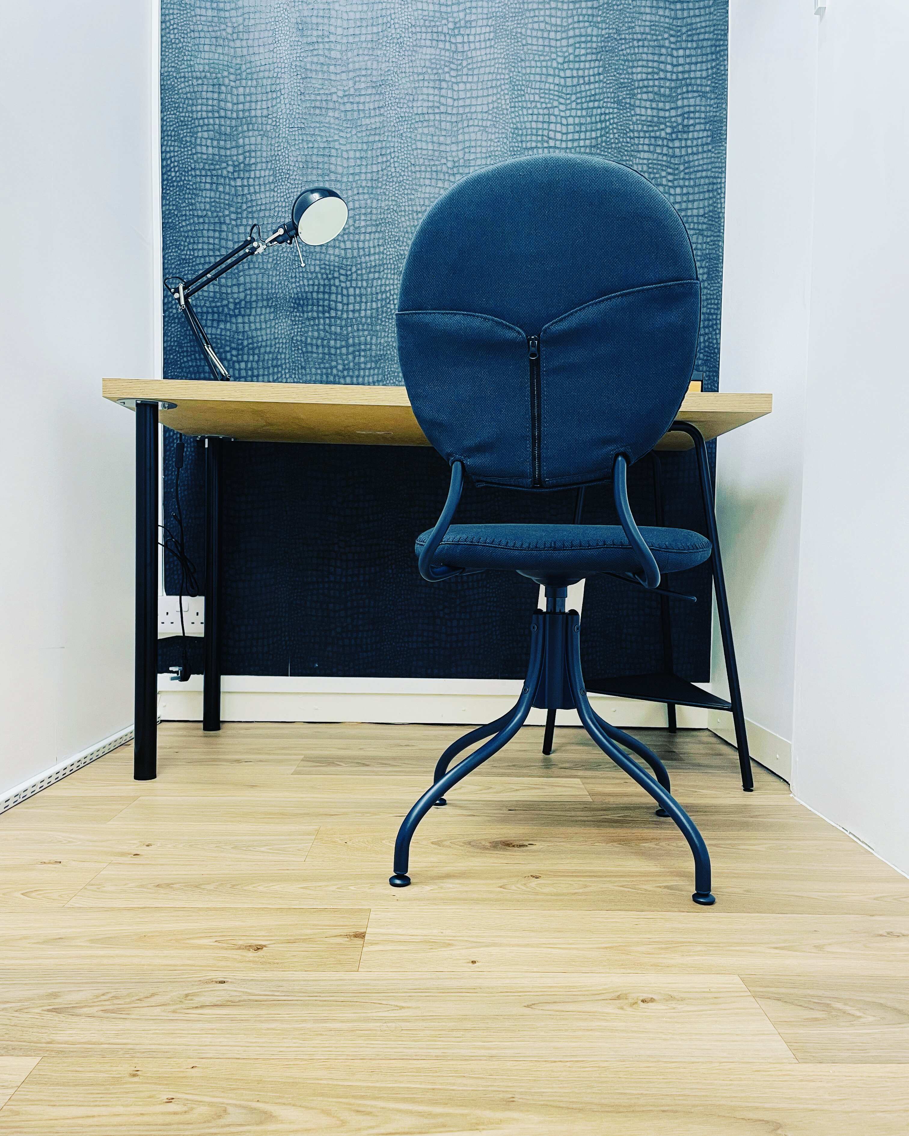 Modern workspace with blue chair, ideal for meetings and brainstorming sessions.