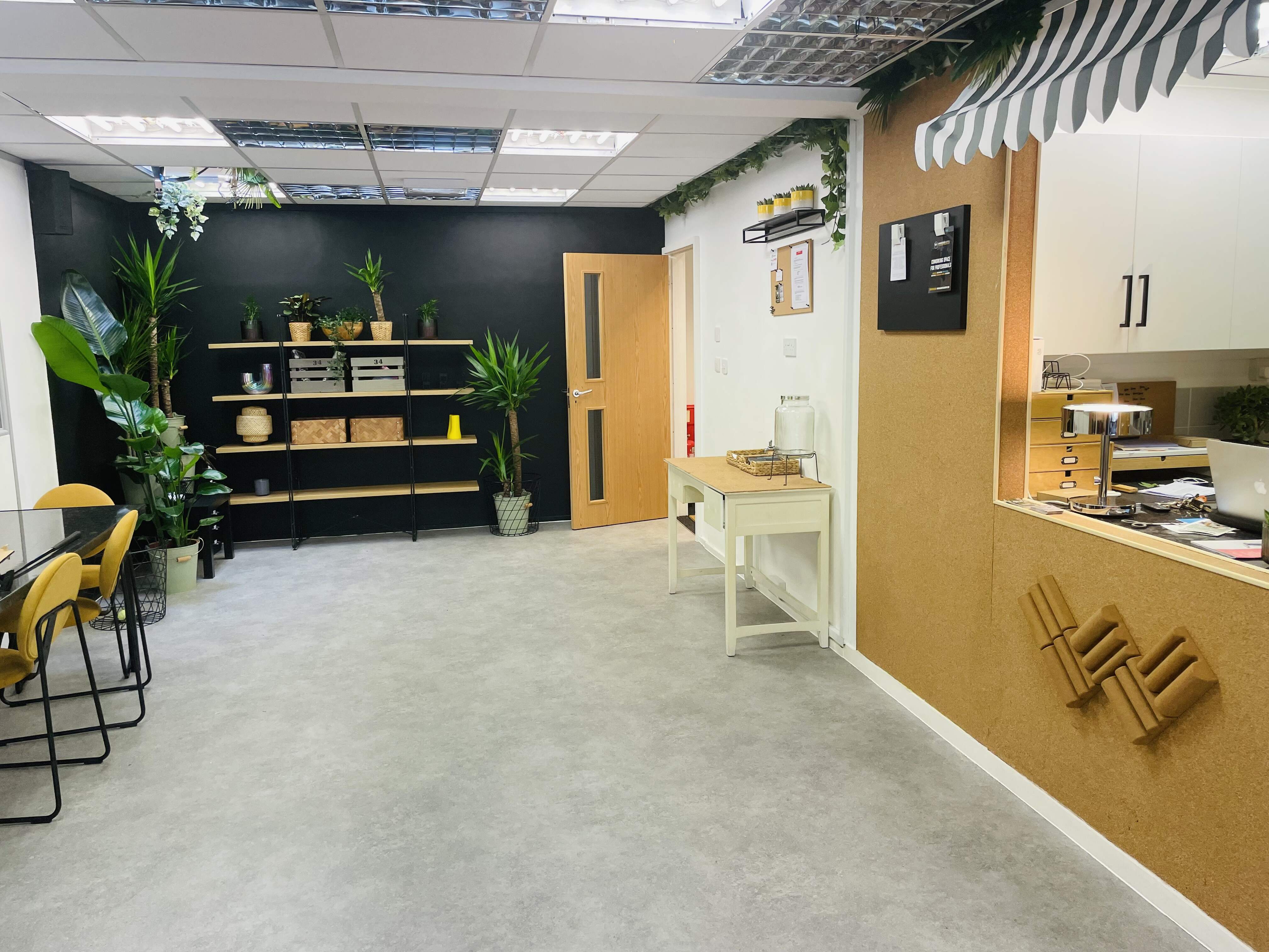 Versatile meeting space at Wanstead Works with greenery, perfect for workshops and team gatherings.