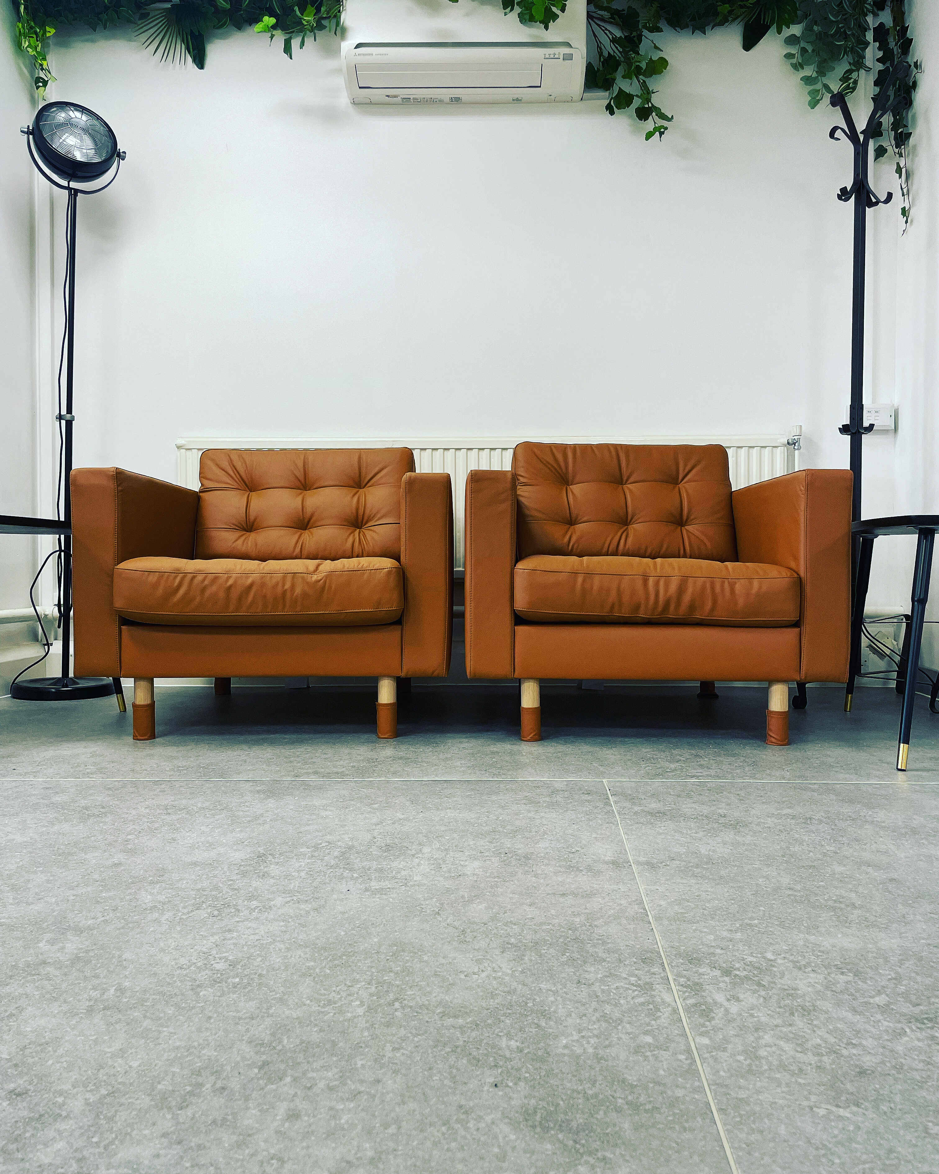 Modern brown armchairs in Wanstead Works, ideal for networking and meetings.