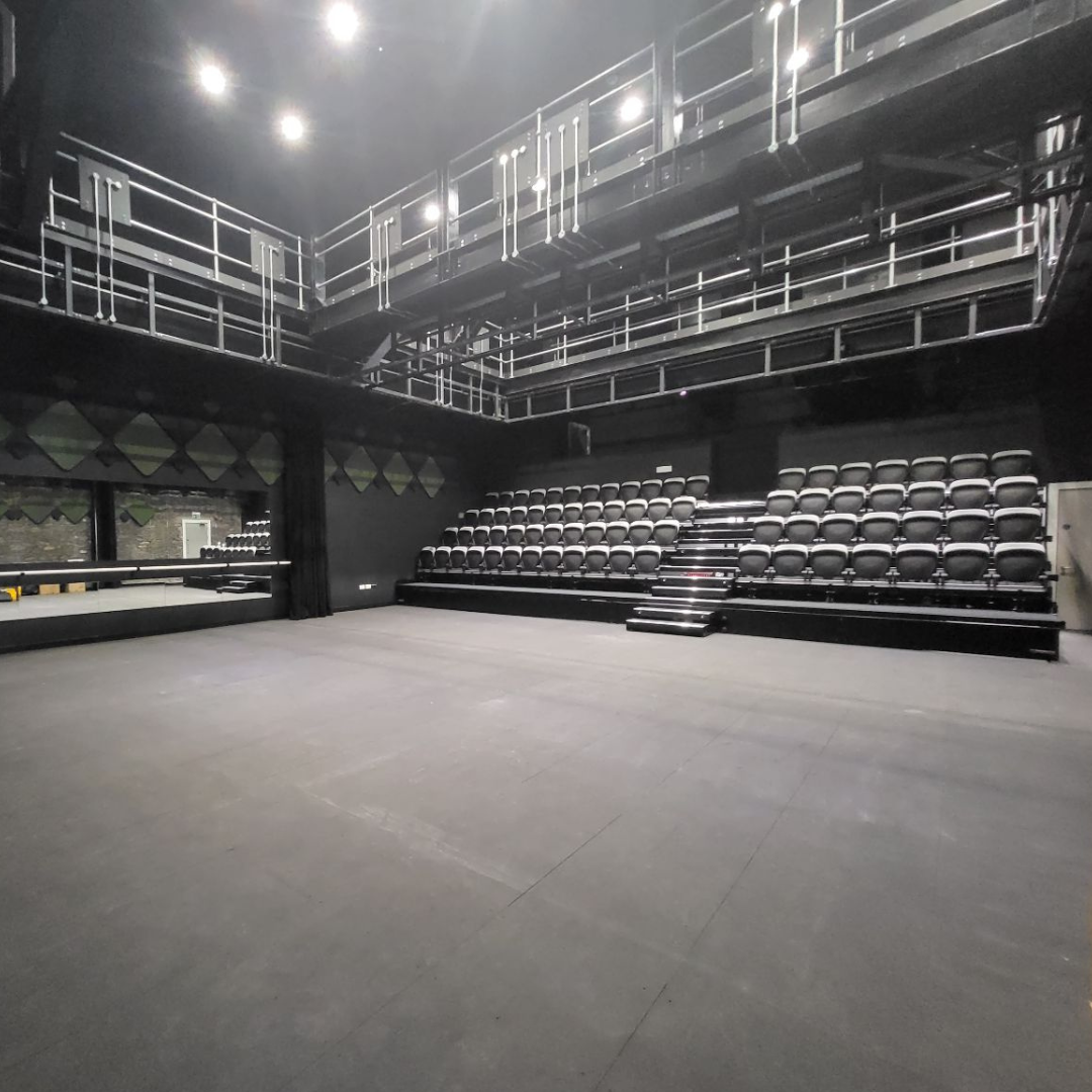 Versatile event space with tiered seating for presentations and performances in Pontypridd.