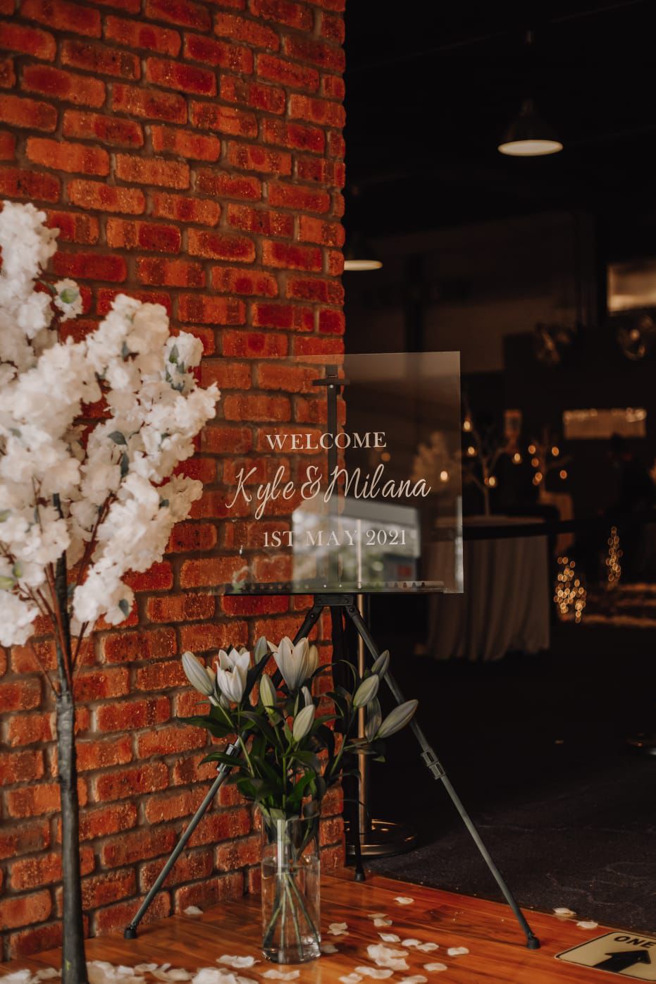 Wedding welcome sign for Kyle and Milana in a rustic function hall setting.