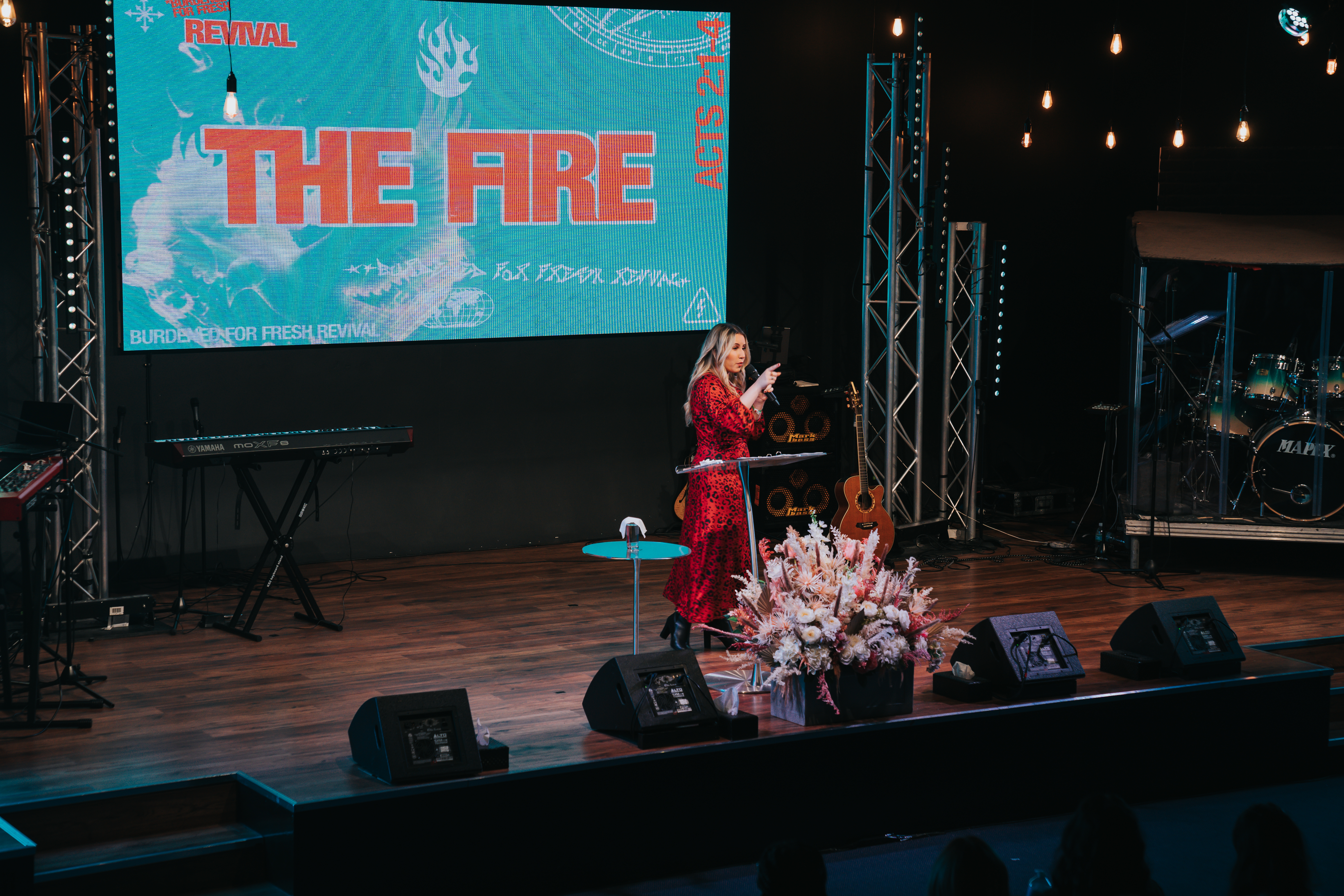 Large Function Hall event setup with speaker, elegant decor, and engaging atmosphere.