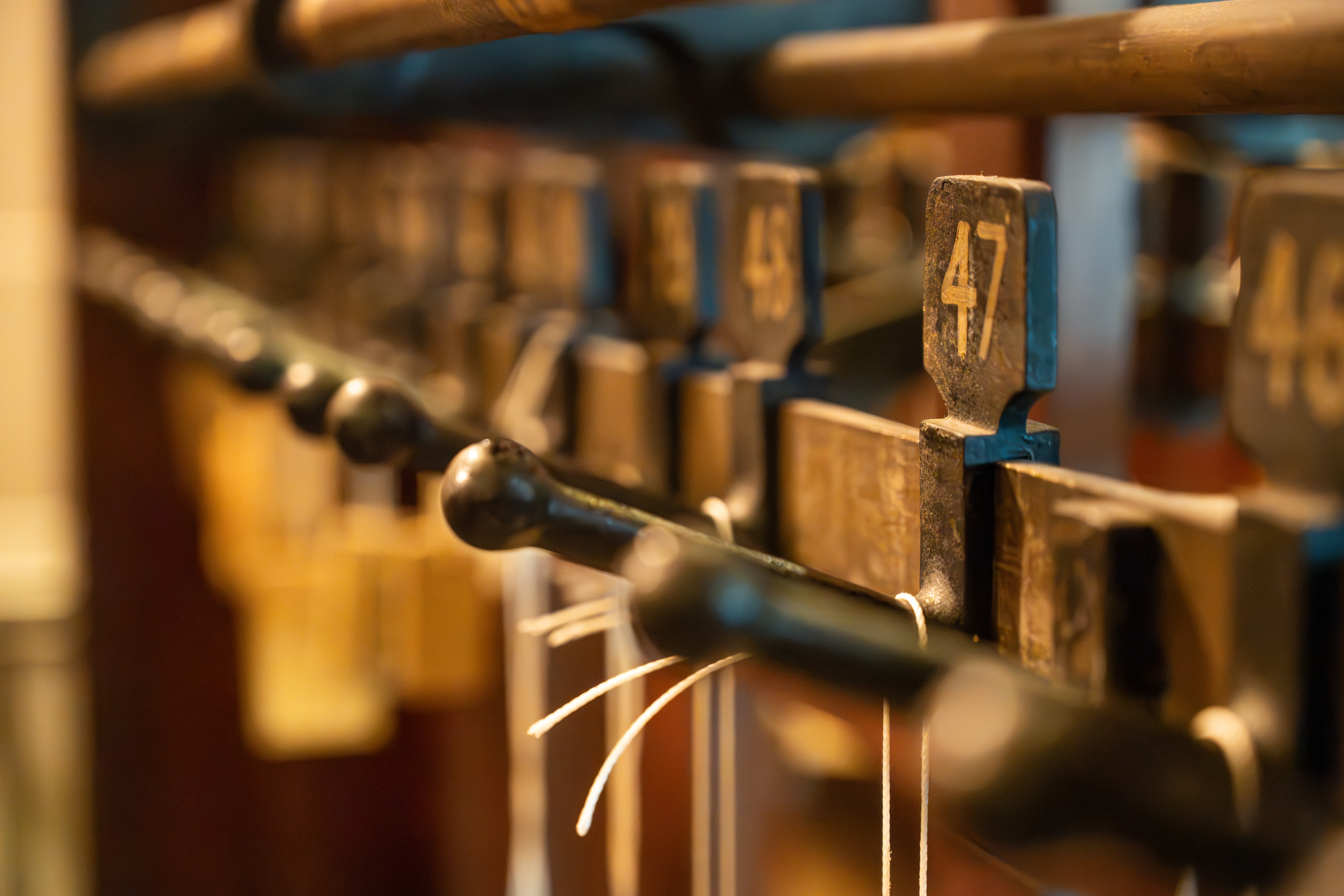 Tower Doors coat check with numbered wooden hooks for events at 60 Great Queen Street.