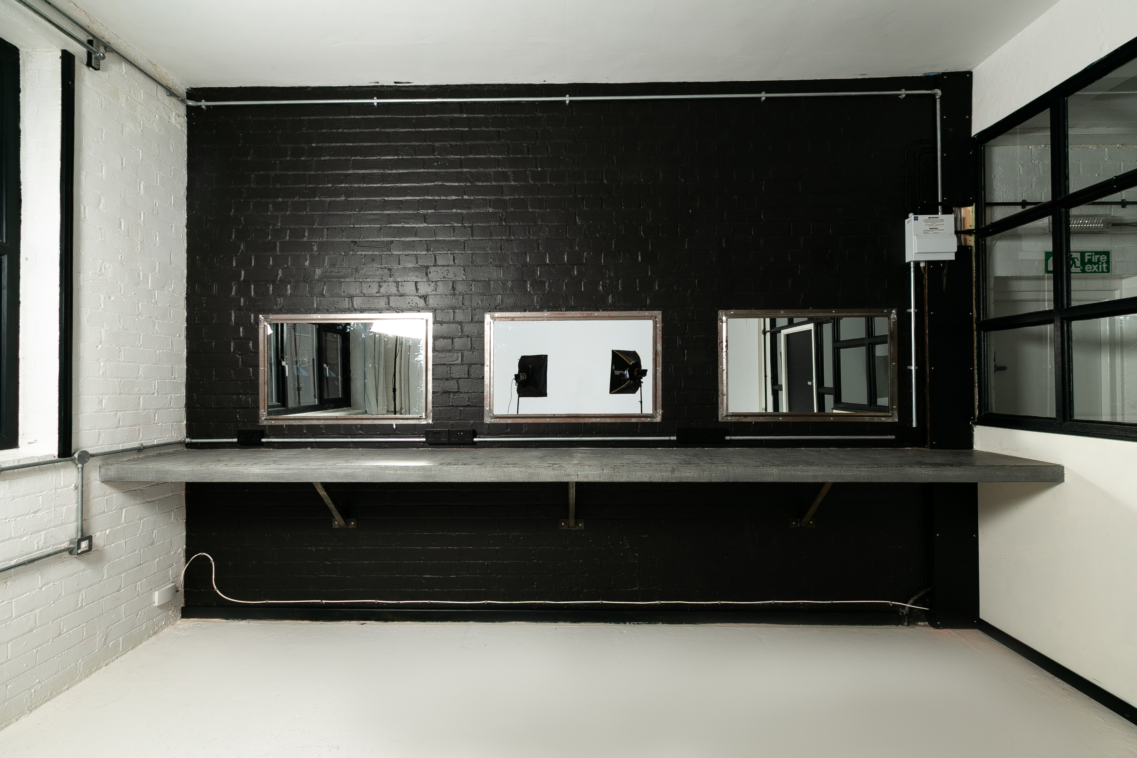 Minimalist Studio 2 with mirrors, ideal for workshops and networking events.