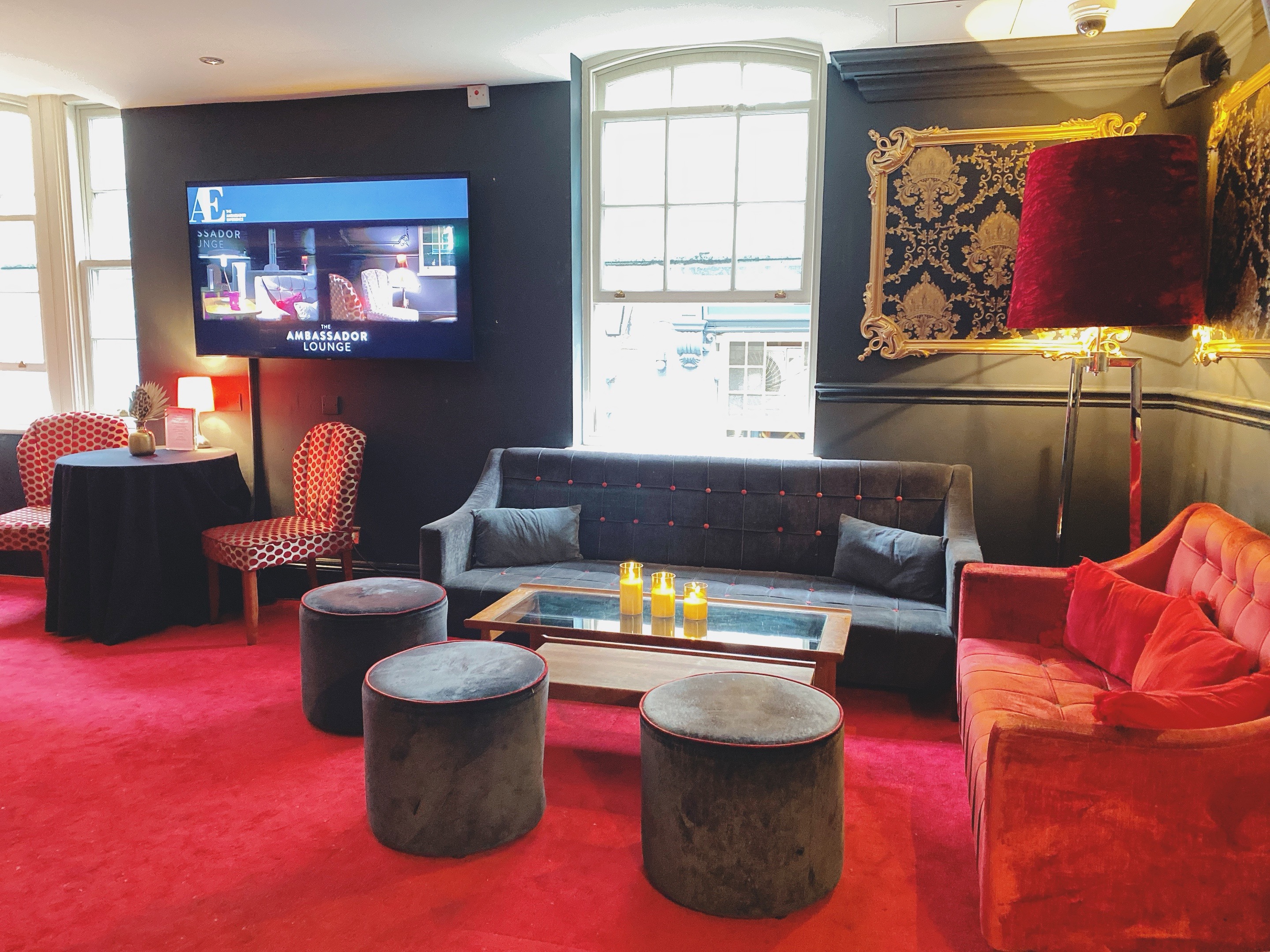 Ambassadors Lounge in ATG VIP, featuring vibrant red carpet for networking events.