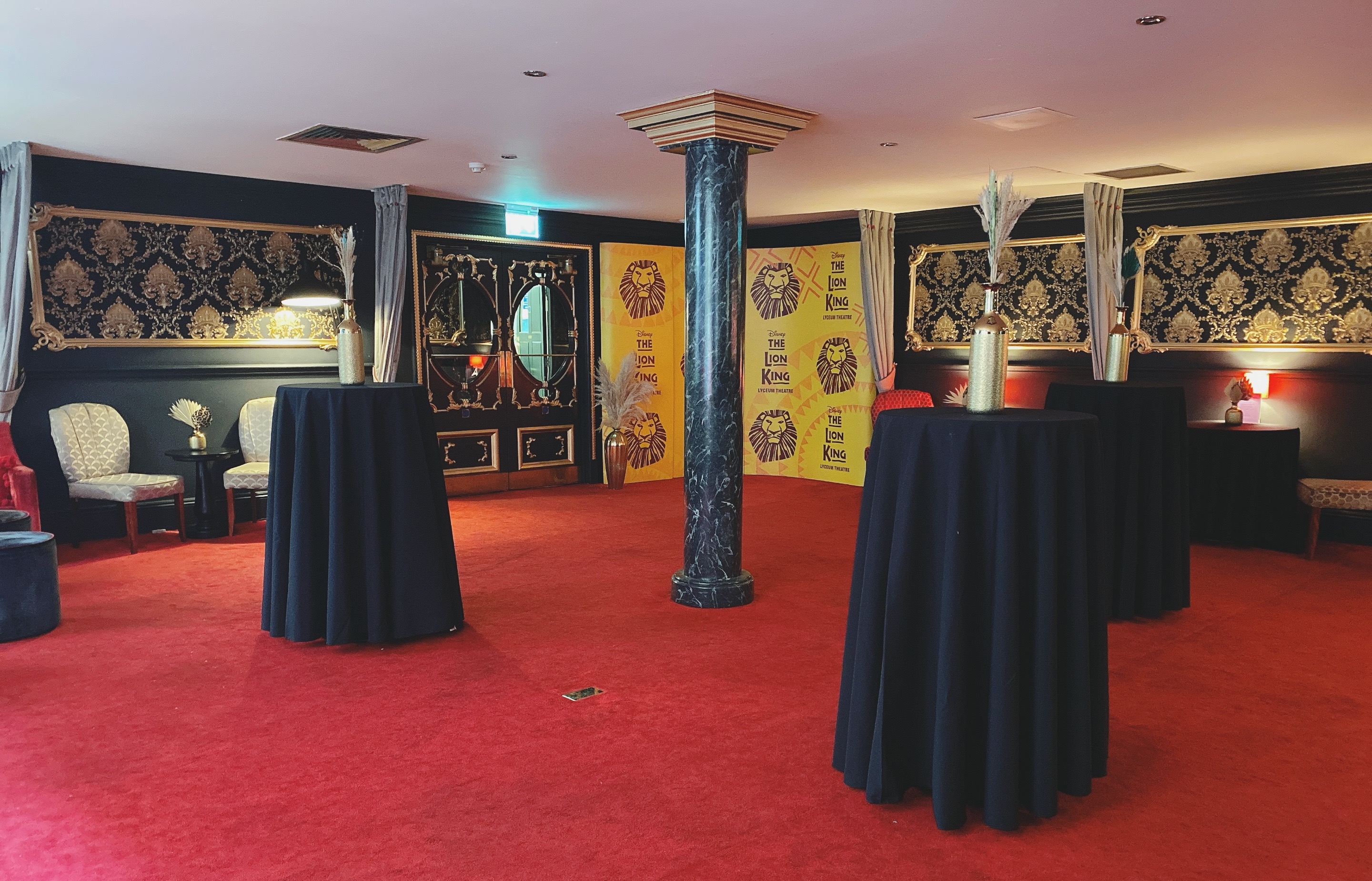 Elegant Ambassadors Lounge with black and gold decor, perfect for upscale events.