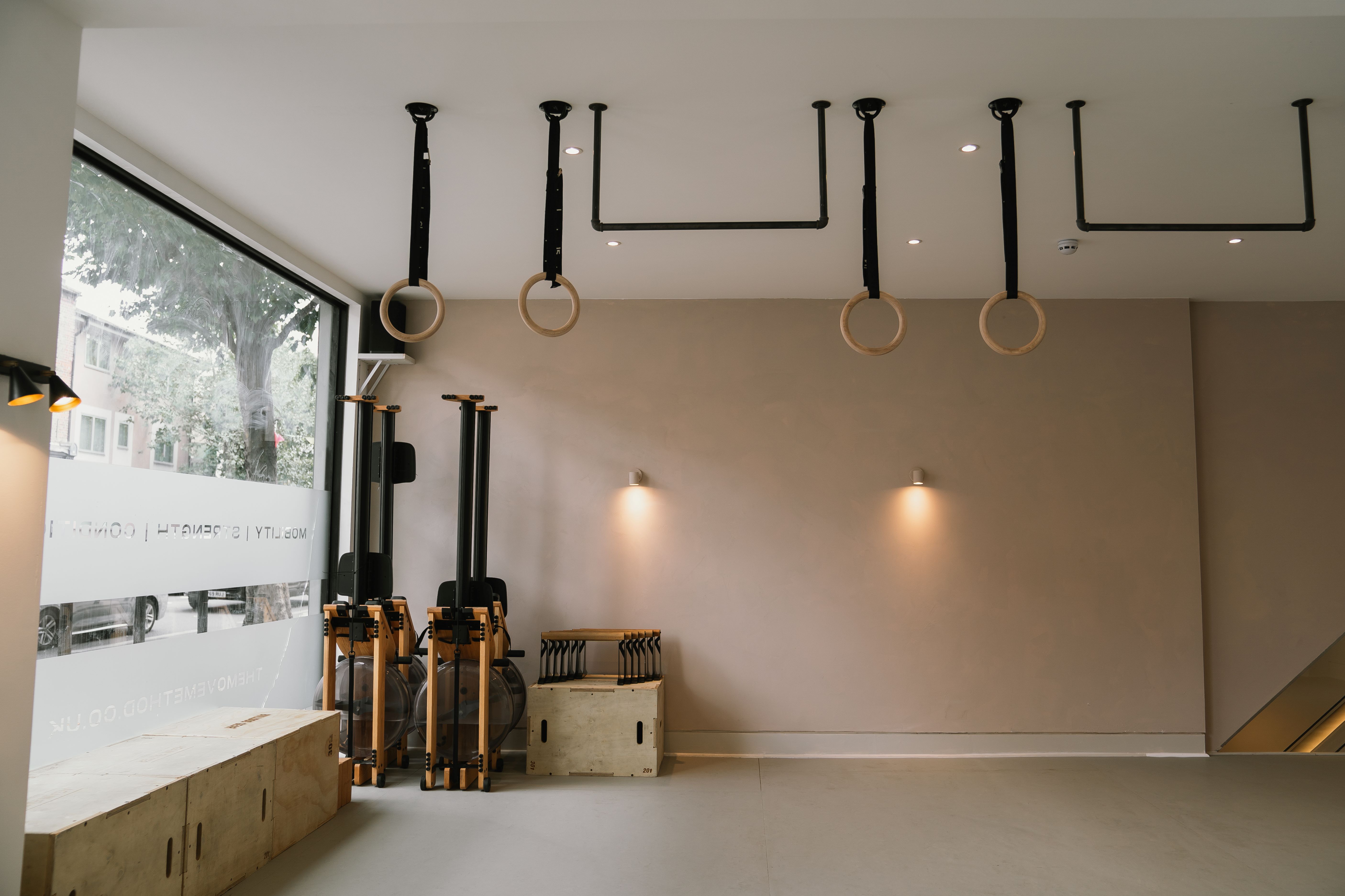 Minimalist event space with natural light, ideal for fitness workshops and creative gatherings.