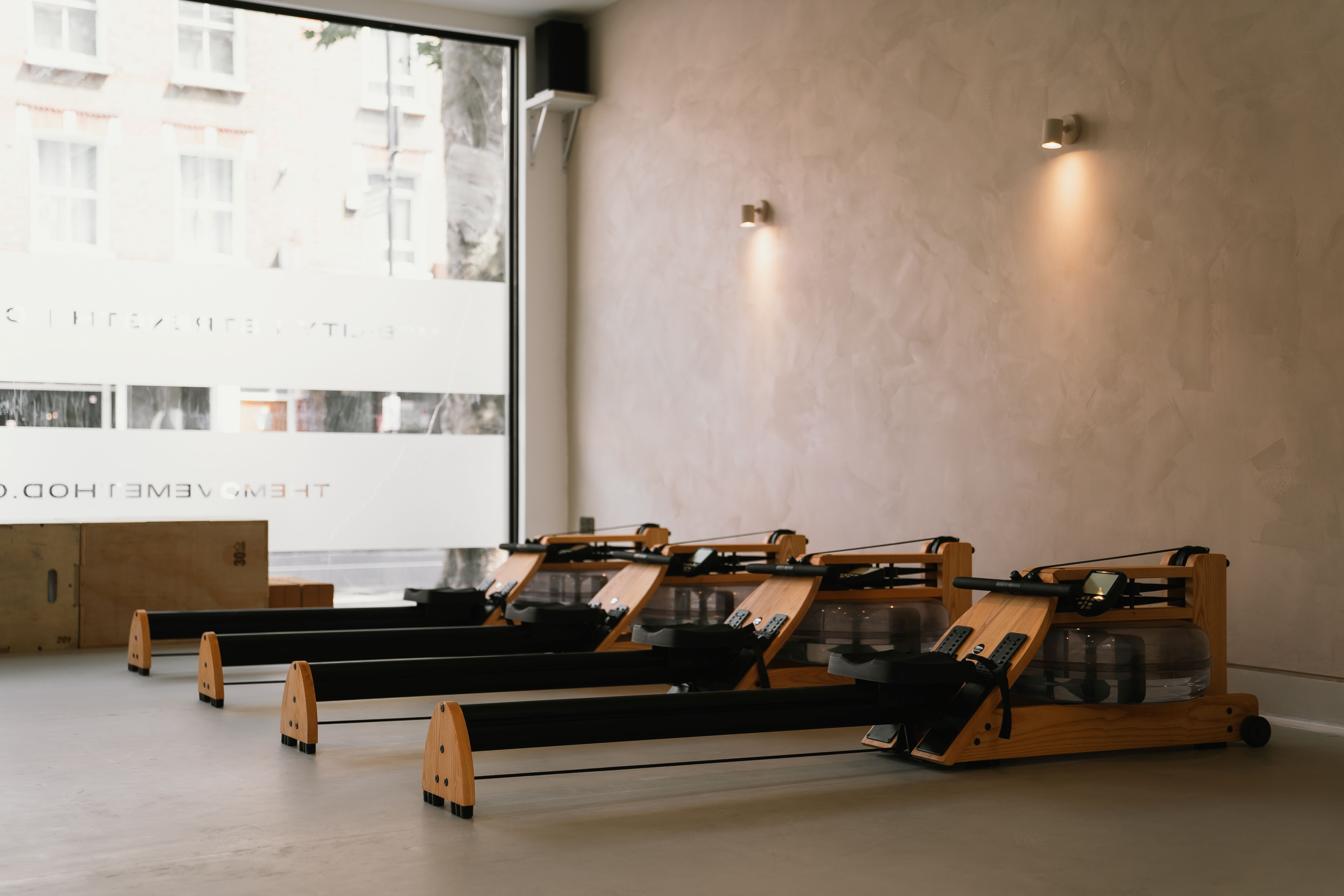 Minimalistic fitness studio with rowing machines for wellness retreats and team-building events.