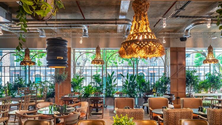 Stylish venue with greenery and warm lighting for meetings and events in Bloomsbury.