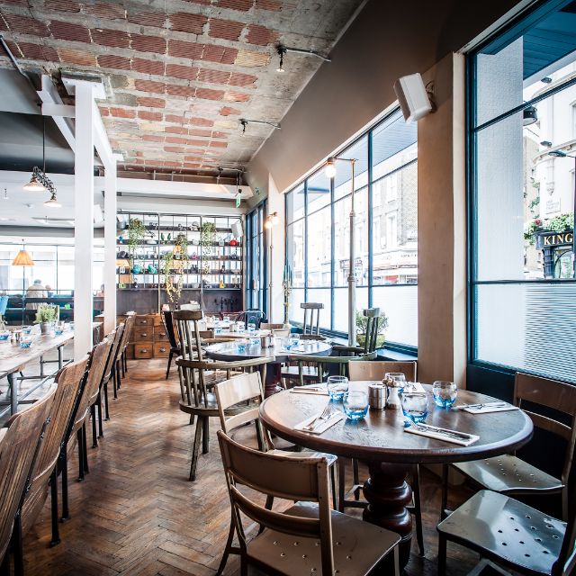 Stylish Riding House Cafe venue with wooden tables, perfect for networking events.