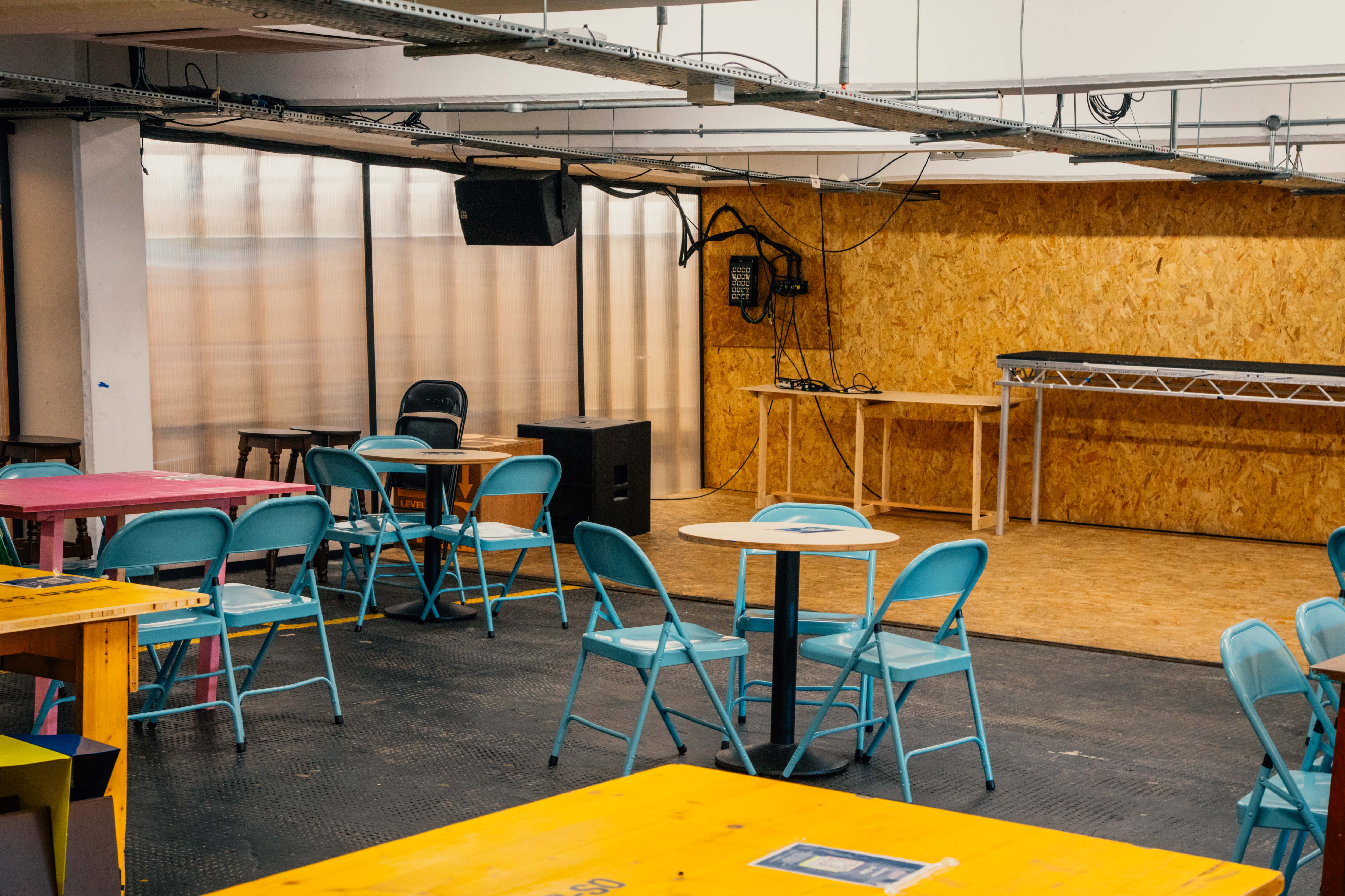 Versatile event space in Peckham Levels with colorful seating for workshops and gatherings.