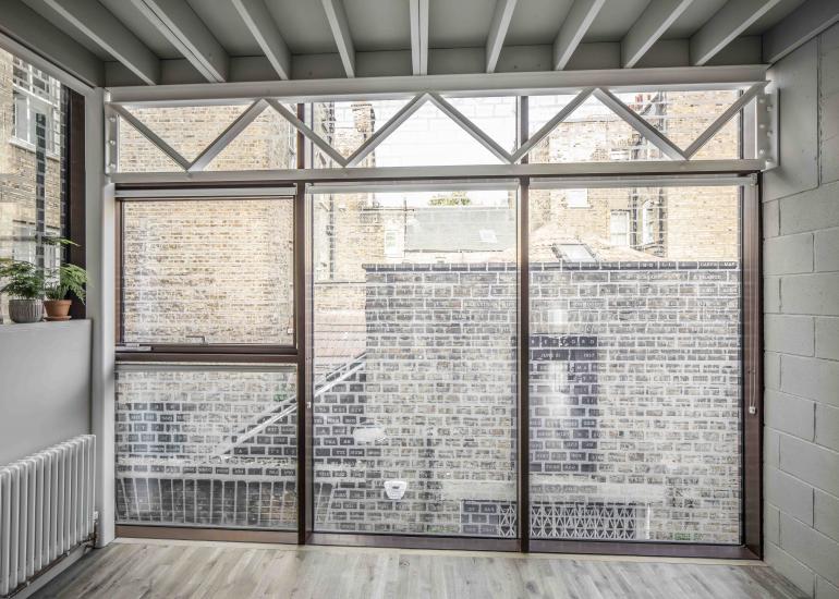 Modern Green Room at Holborn House, ideal for meetings and workshops with natural light.