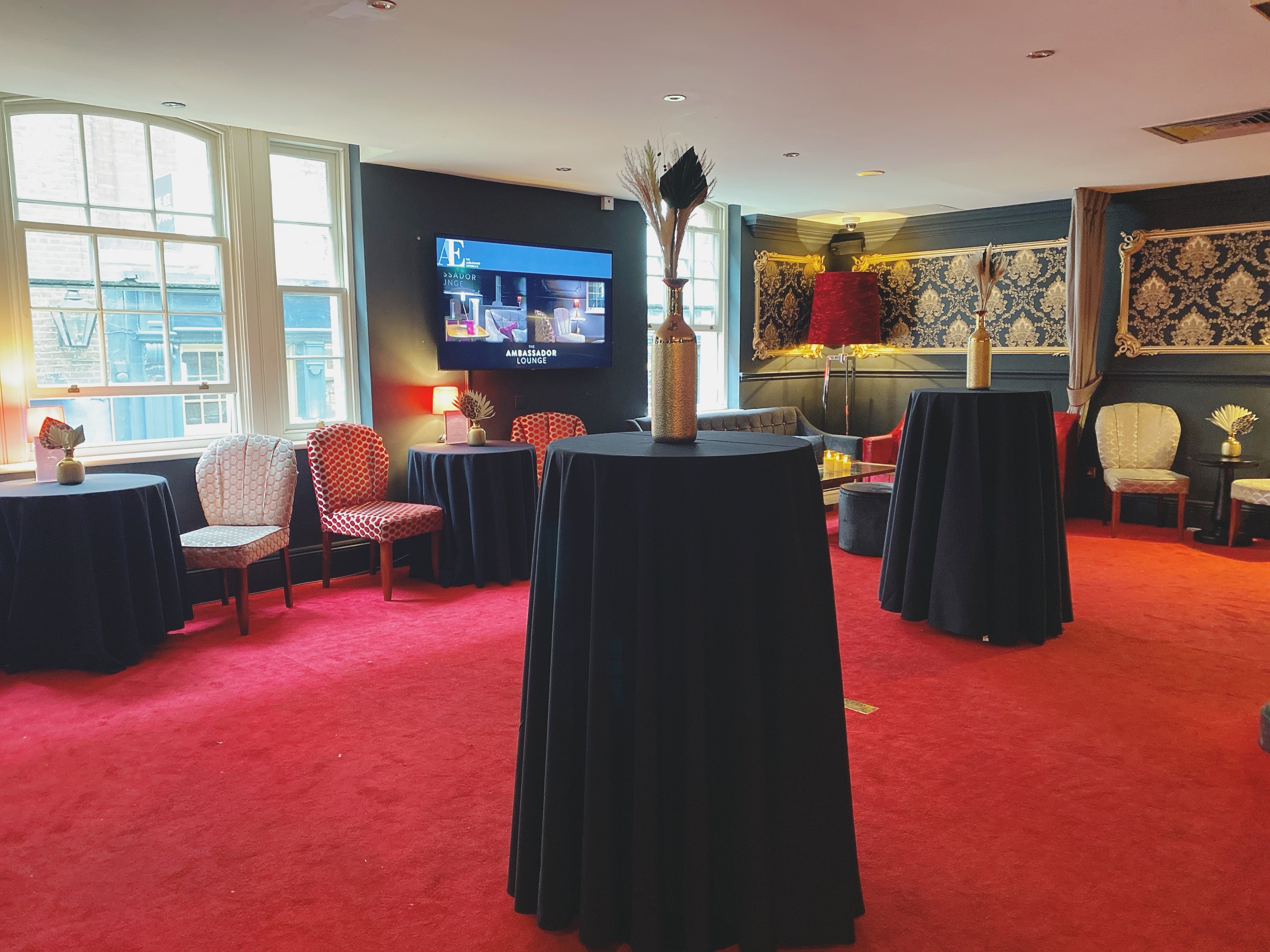Ambassadors Lounge event space with high-top tables, ideal for networking and receptions.