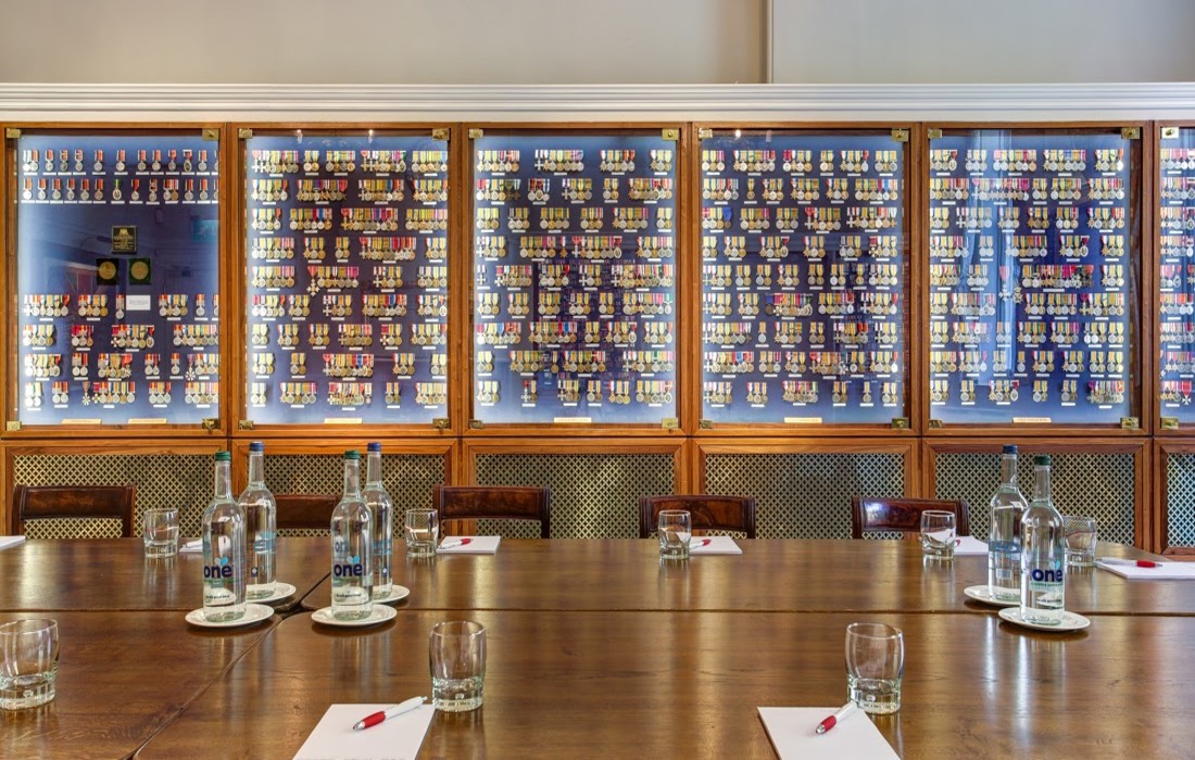 Medal Room in HAC: elegant wooden table set for intimate meeting and networking event.