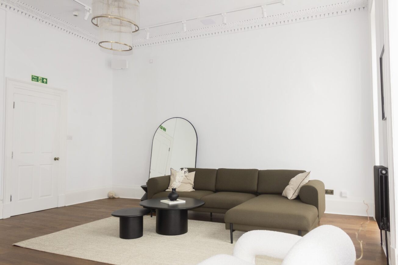 Modern minimalist meeting space with sectional sofa for informal gatherings.