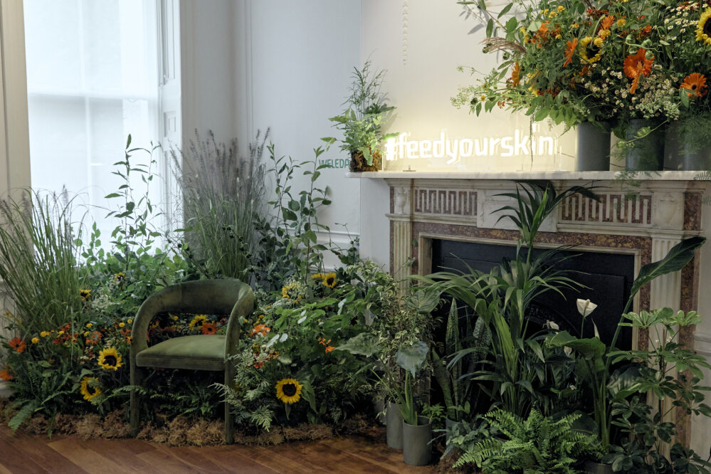 Evelyn Room event space with cozy chair, vibrant flowers, perfect for intimate gatherings.