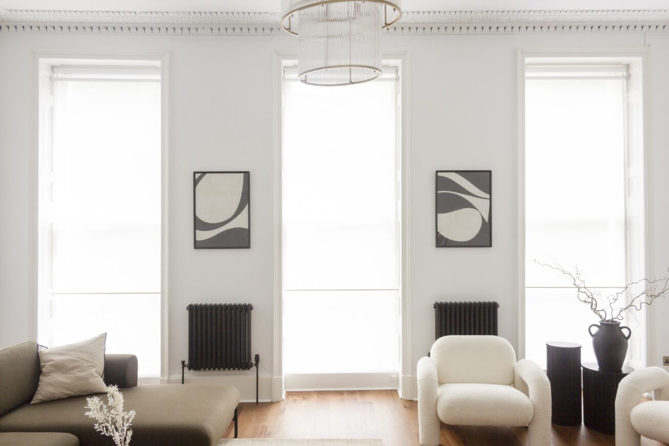 Modern minimalist meeting space with natural light, ideal for creative gatherings.