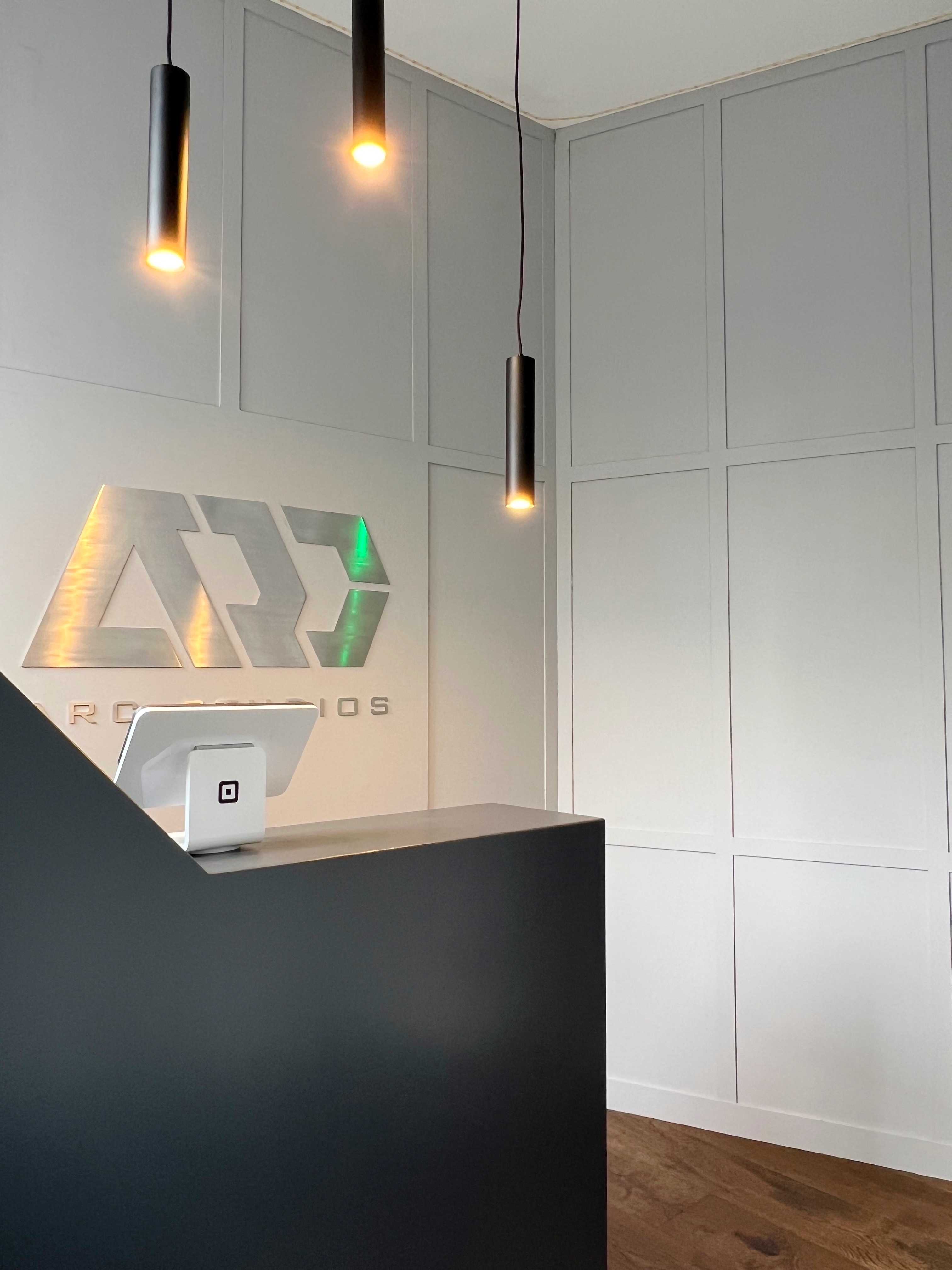 Sleek reception area in ARC STUDIOS for corporate events with illuminated logo.