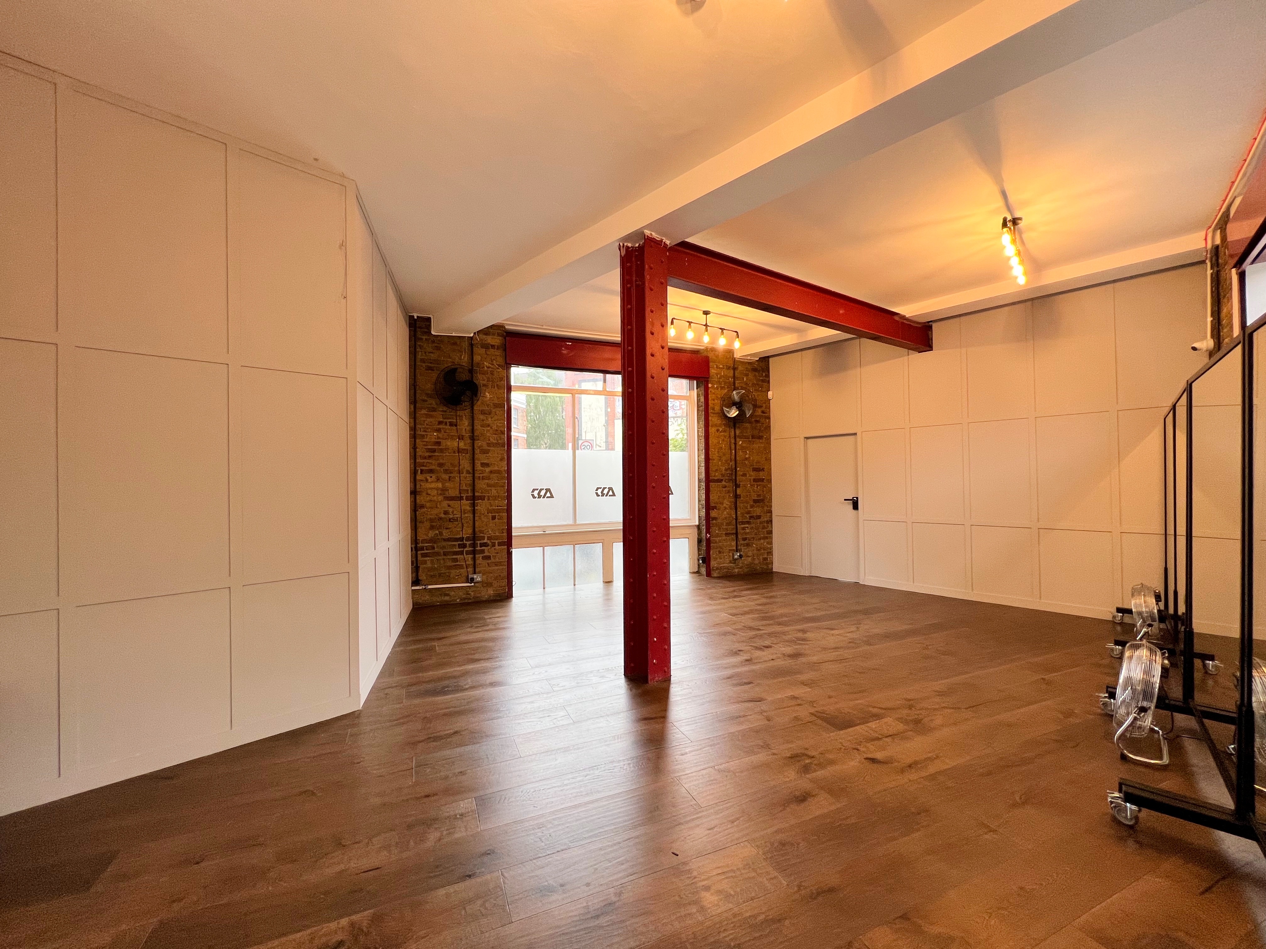 Modern event space with exposed brick walls, ideal for meetings and gatherings.