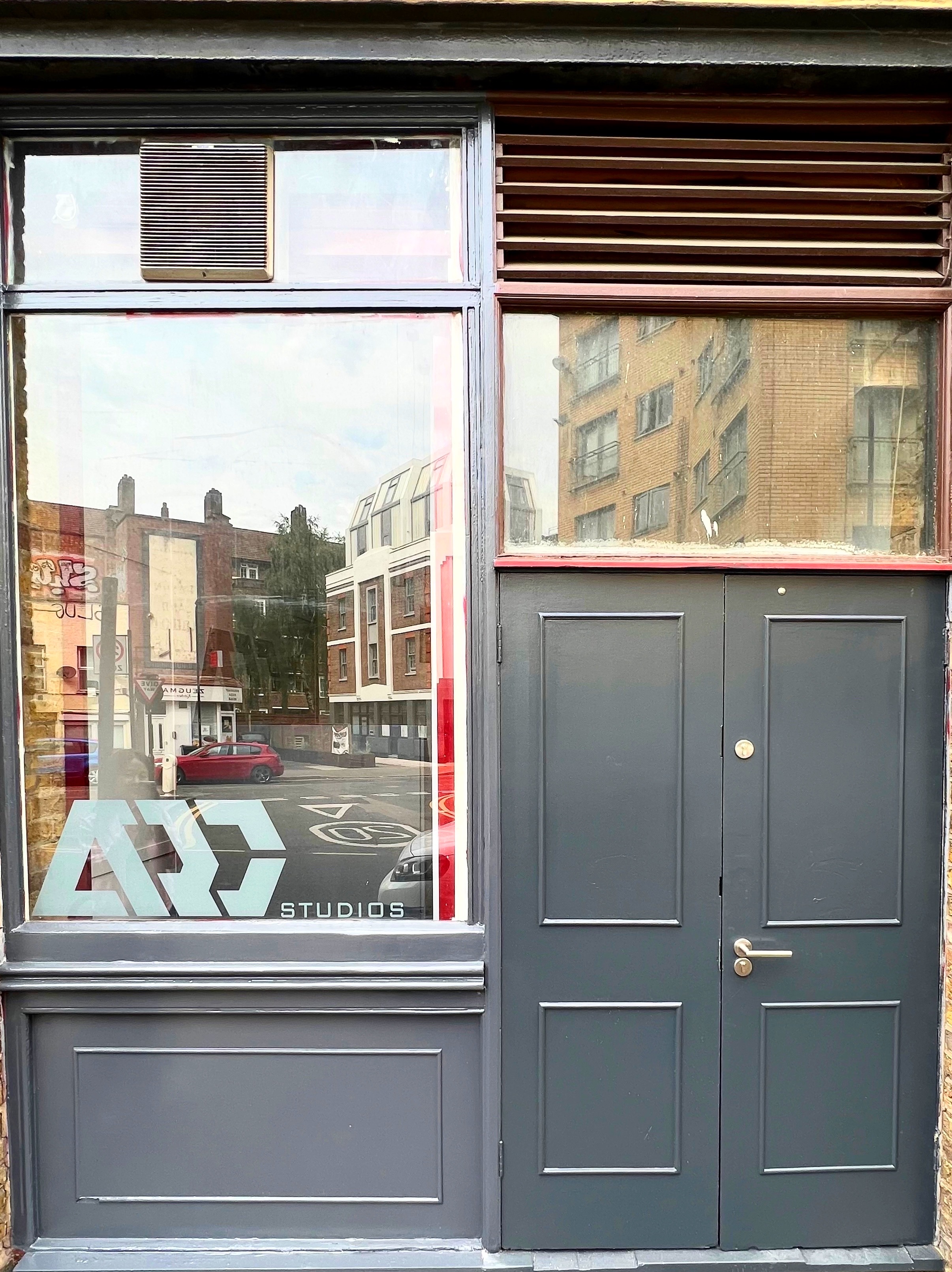 Modern studio entrance with large window, ideal for creative events and workshops.