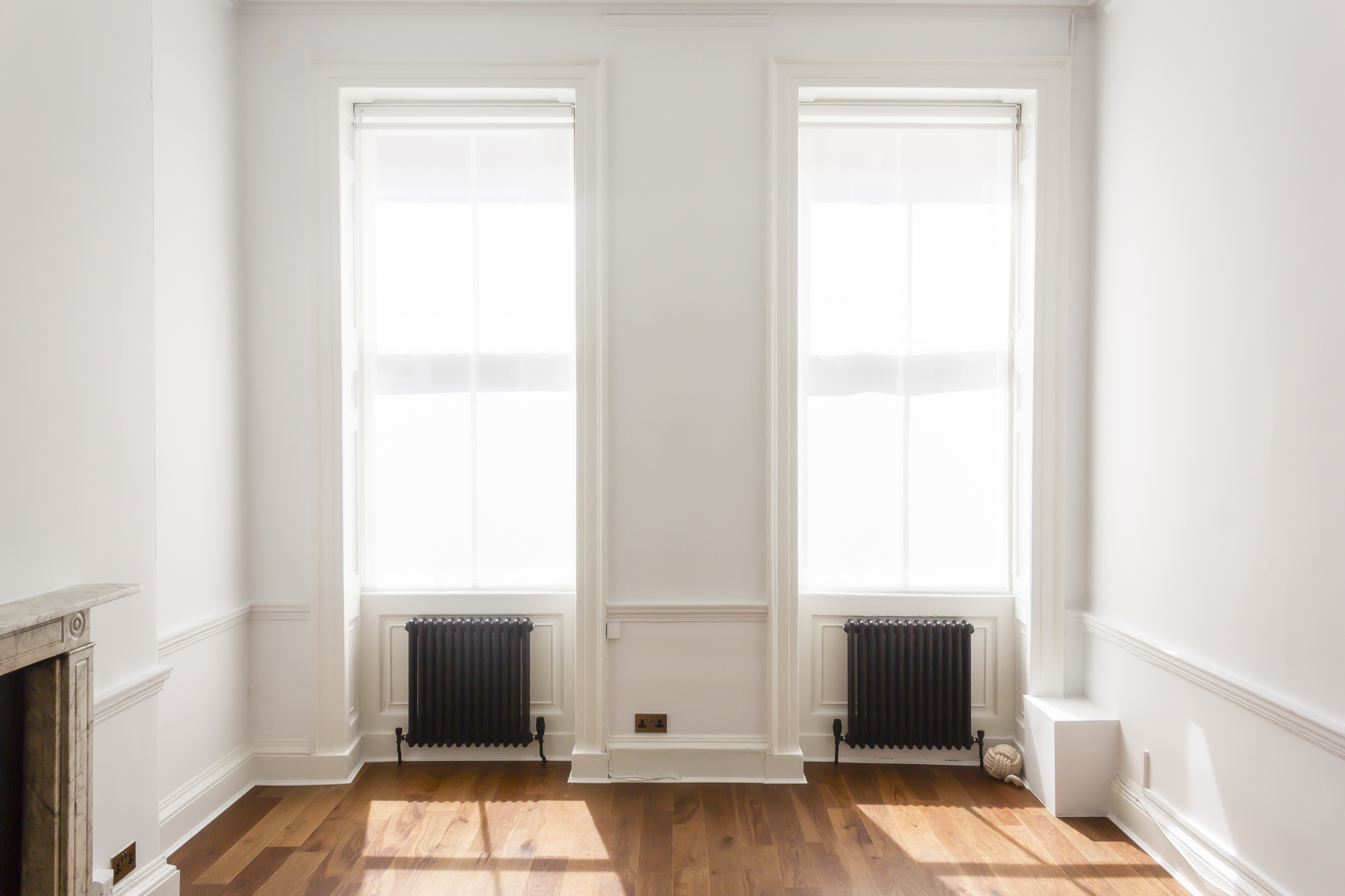 Bright minimalist event space in Otto Room, featuring large windows for natural light.
