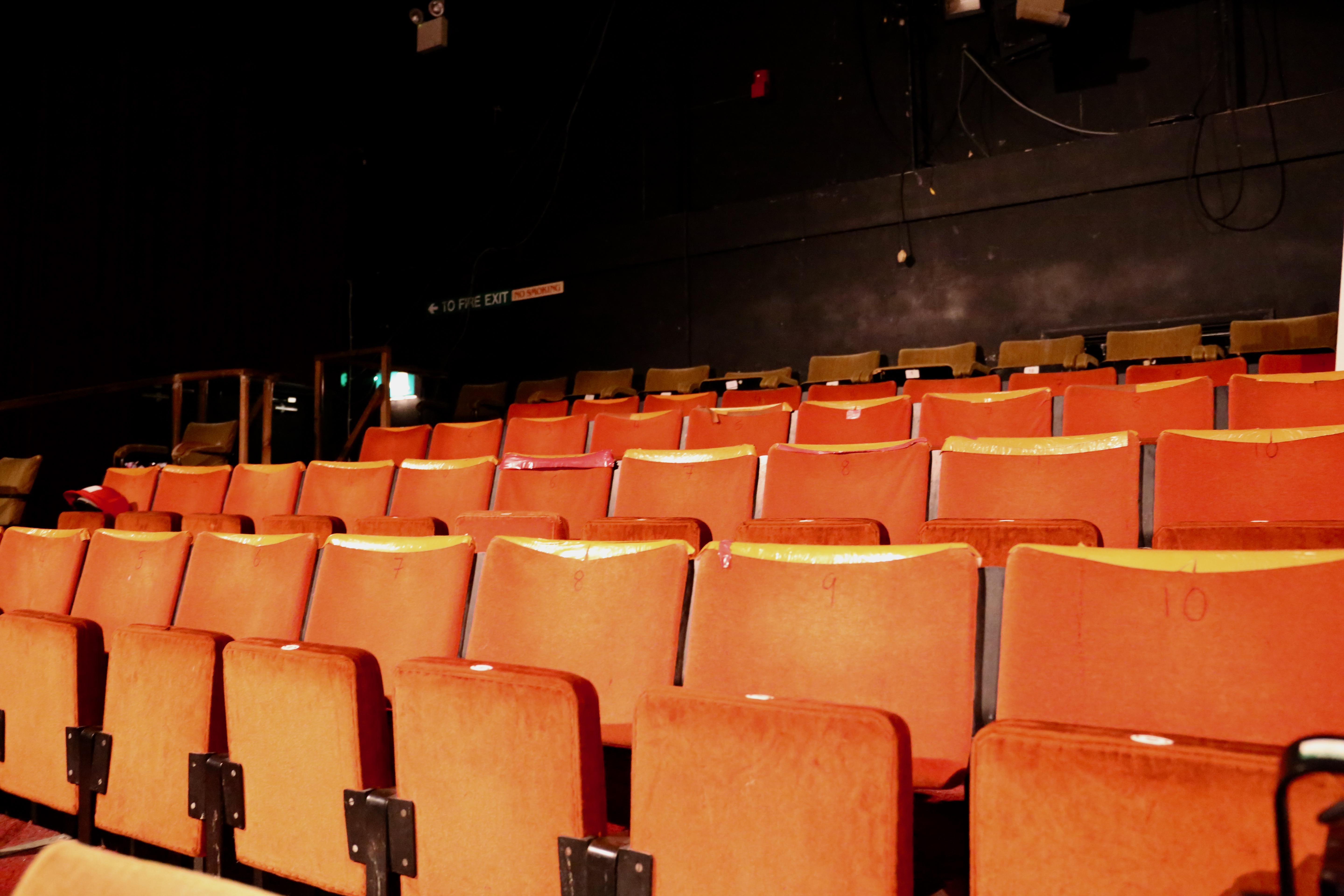 Empty theater seats in CYTO's Green Room, ideal for engaging events and meetings.