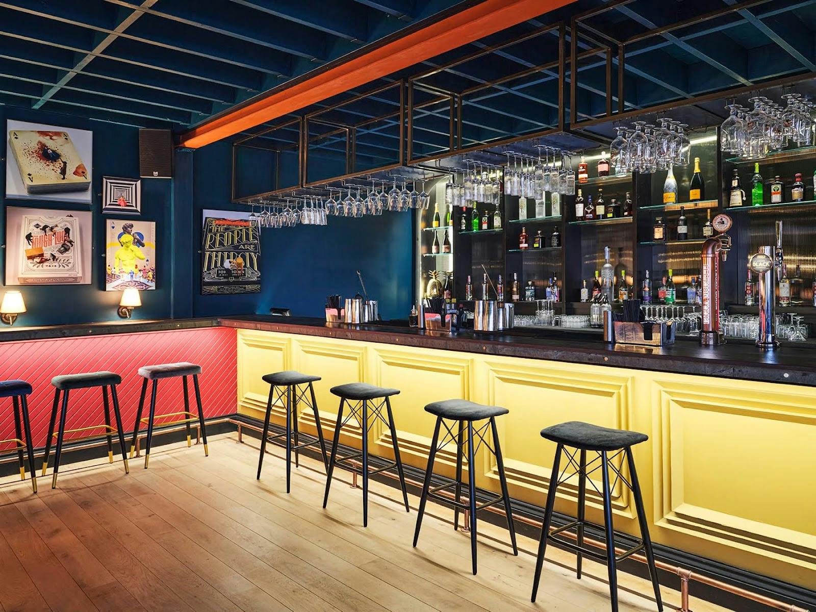 Rooftop Lounge at The Corin: modern bar, vibrant decor for networking events.