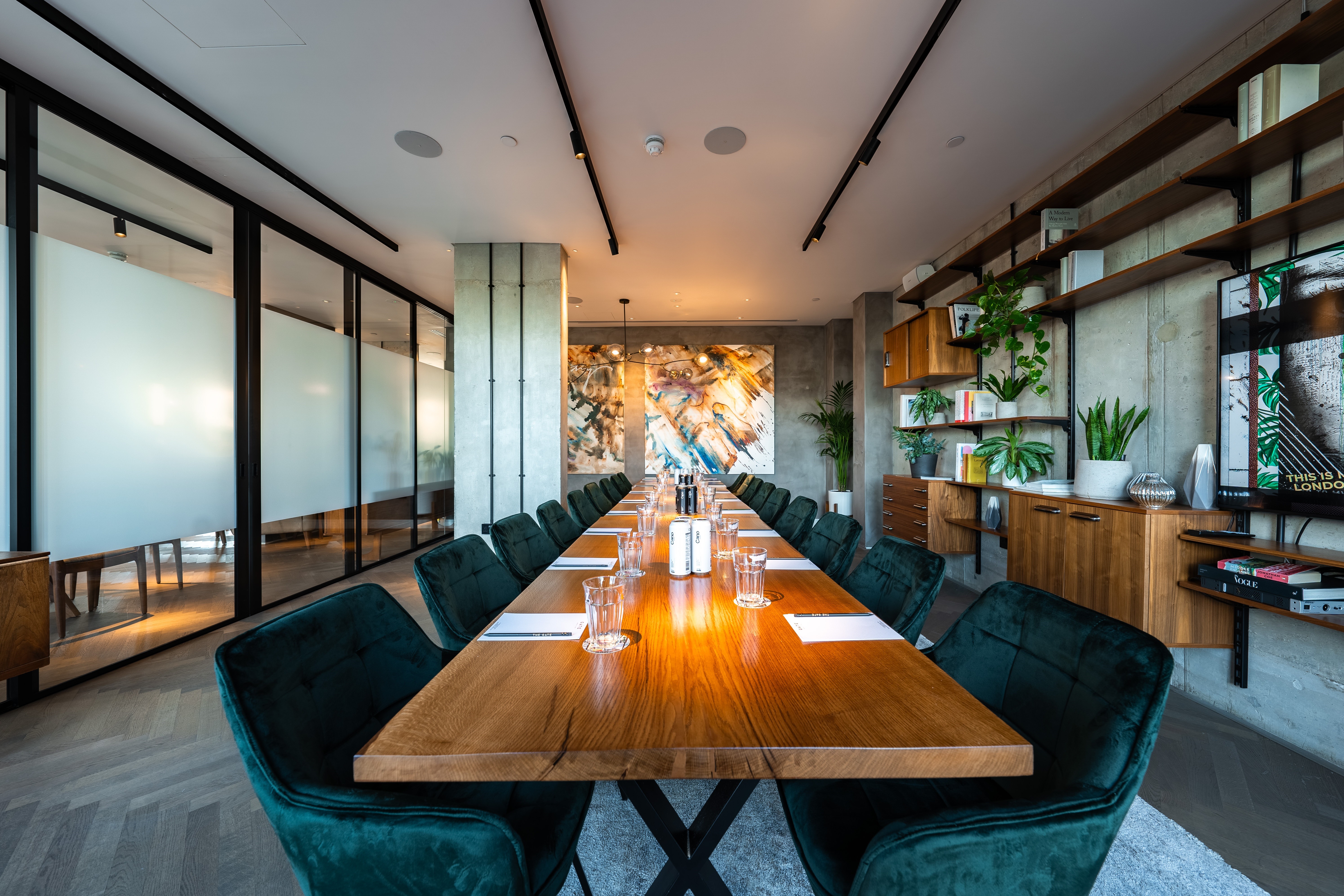 Modern meeting space with wooden table and plush chairs at The Gate Aparthotel Aldgate East.