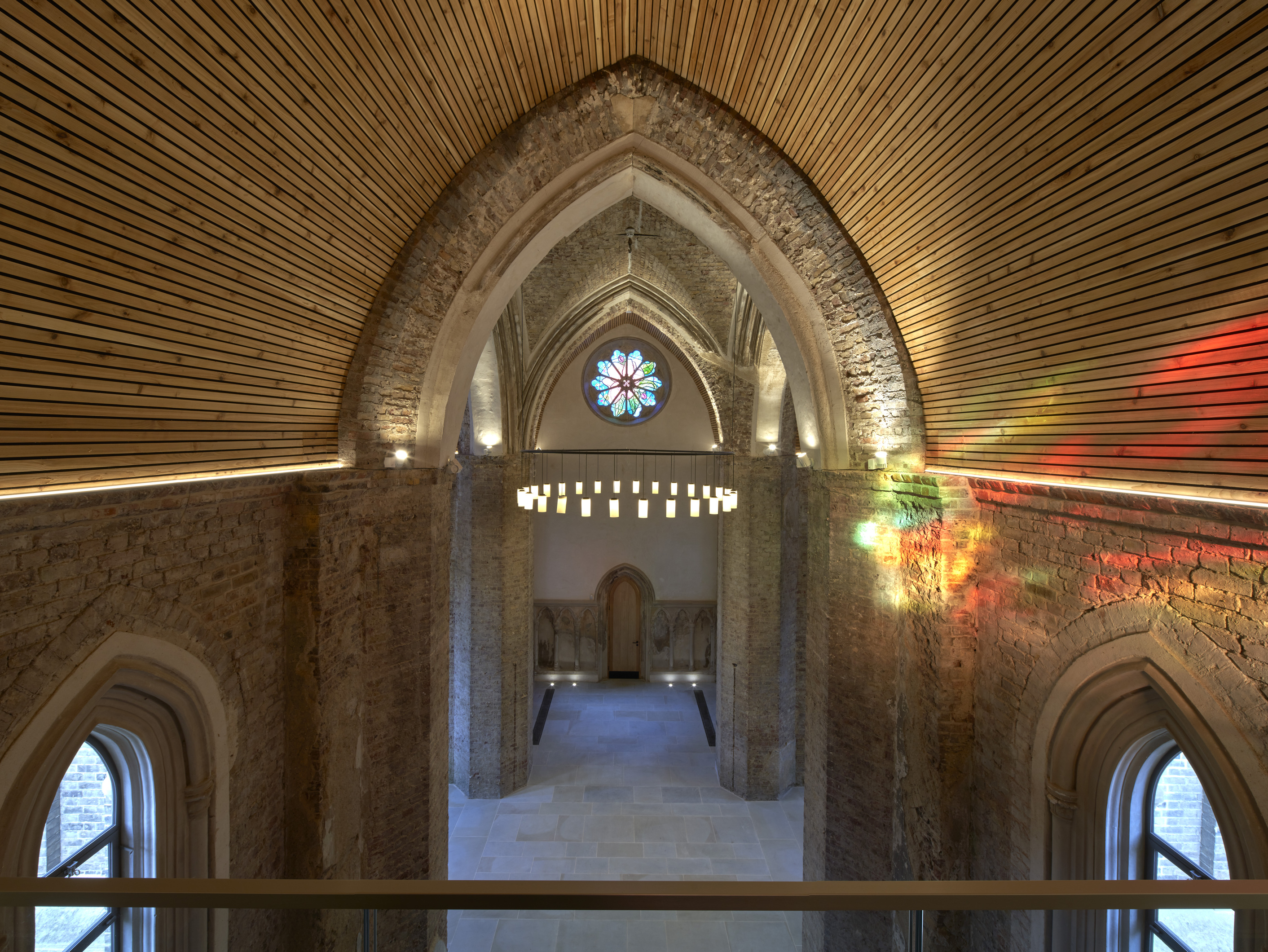 Elegant event space in Abney Park Chapel with high arched ceilings and stained glass.