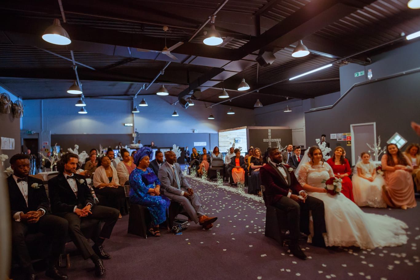 Wedding ceremony in organized Function Hall, featuring elegant decor and attentive guests.