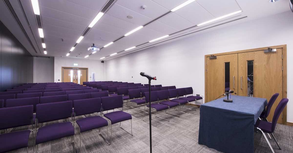 "Hall 2 ICC Belfast with purple chairs, ready for presentations and workshops."