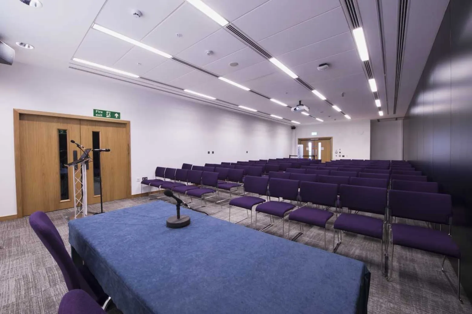 Meeting room in ICC Belfast with purple chairs, ideal for presentations and discussions.