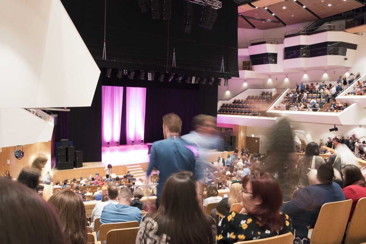 Main Auditorium at ICC Belfast, bustling with attendees for engaging live events.
