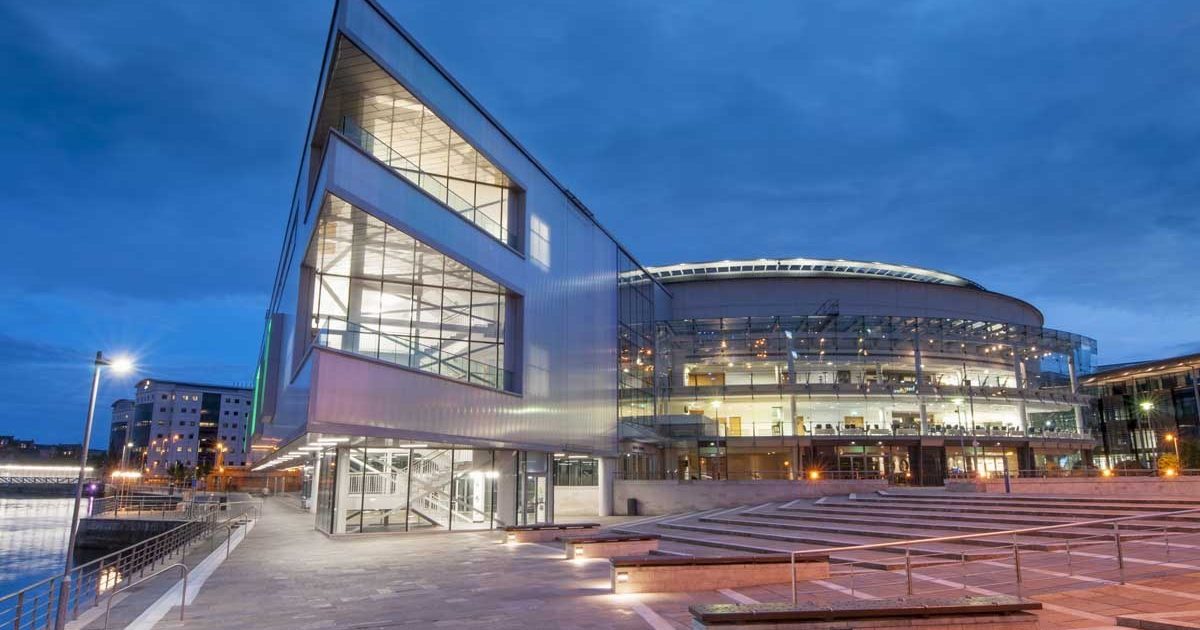 Main Auditorium at ICC Belfast, modern venue with glass facade for conferences and events.