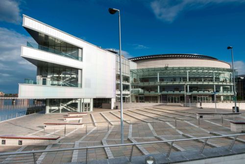Modern ICC Belfast venue with glass facades, perfect for conferences and gatherings.