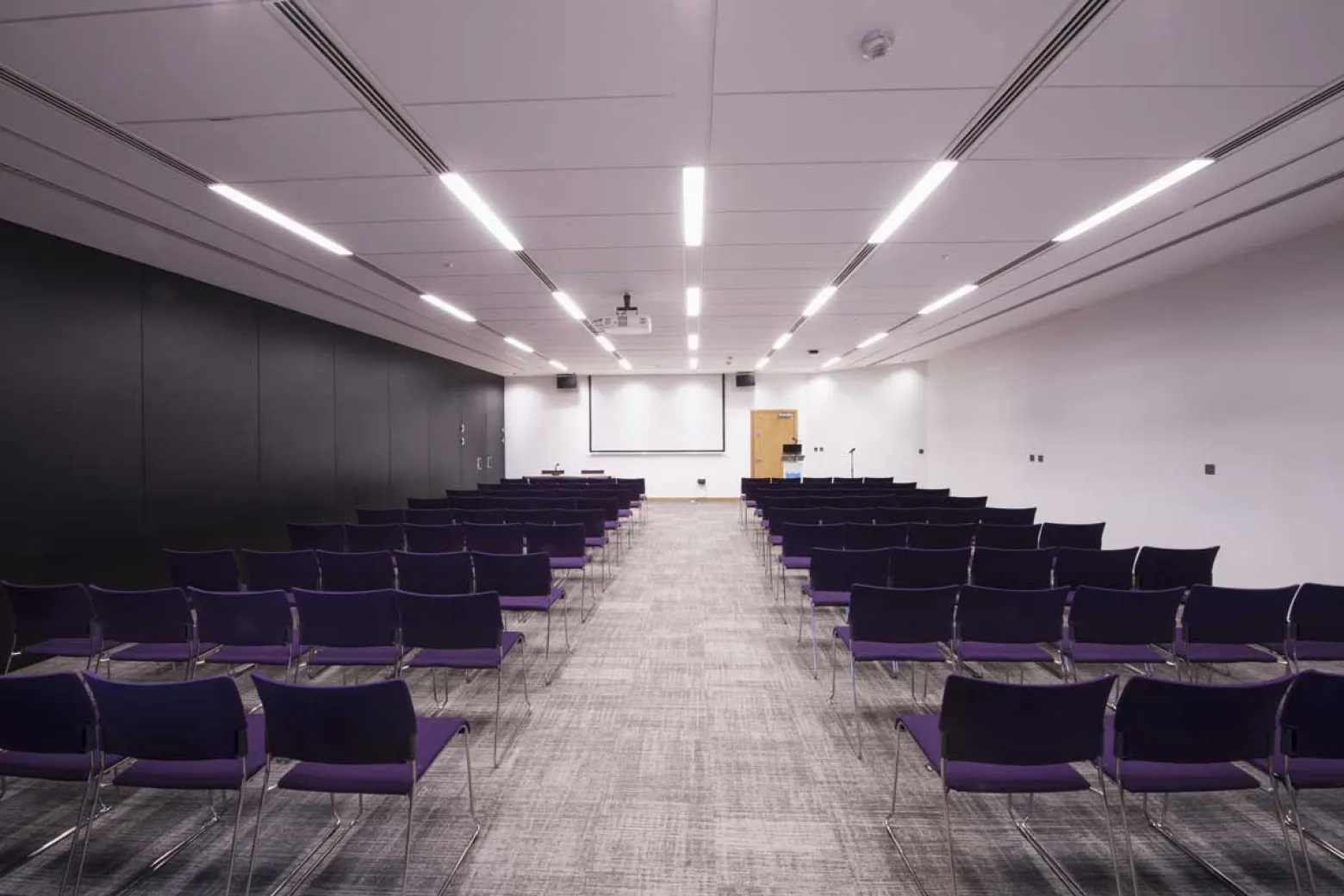 Modern event space in ICC Belfast with purple chairs, ideal for conferences and workshops.