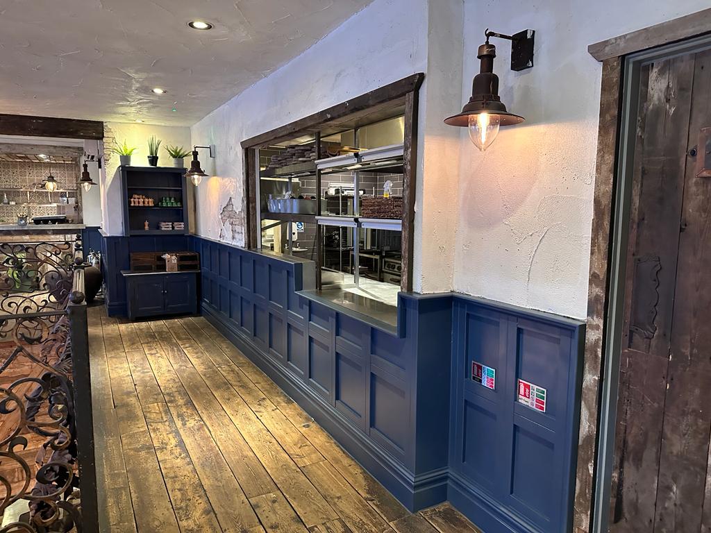 Rustic modern venue with wooden flooring, perfect for networking events and gatherings.