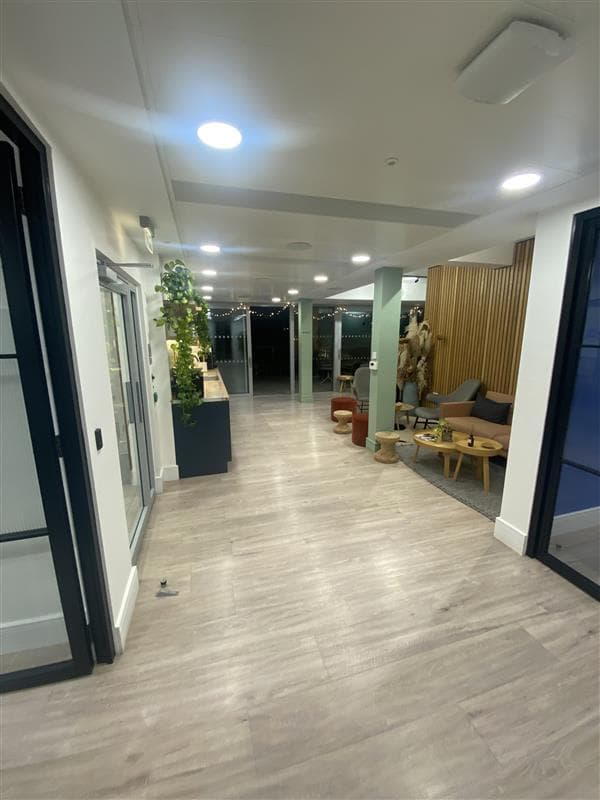 Modern event space with sleek hallway and lounge, perfect for networking and meetings.