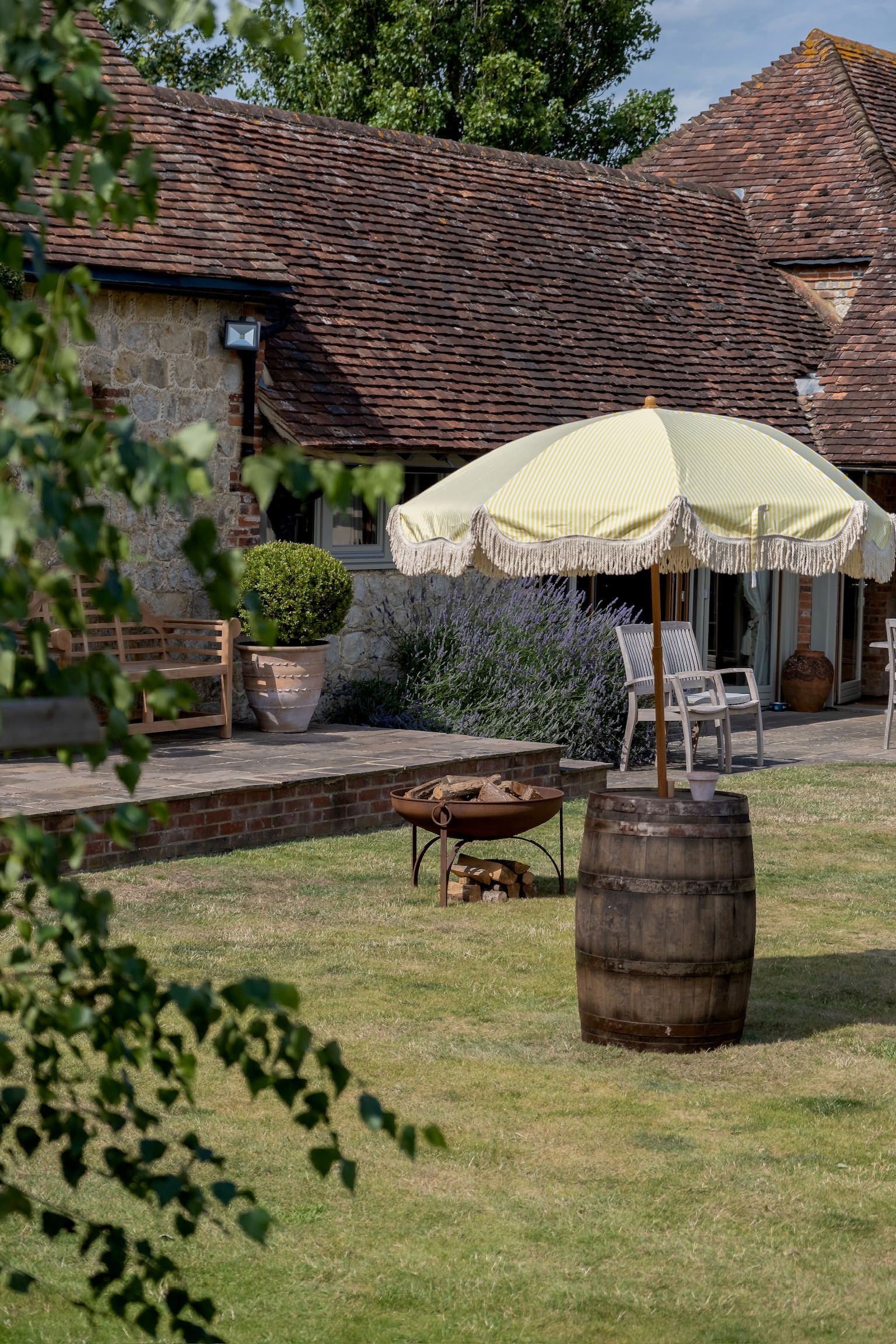Ruffynes Barn outdoor venue with vintage umbrella, ideal for summer gatherings and events.