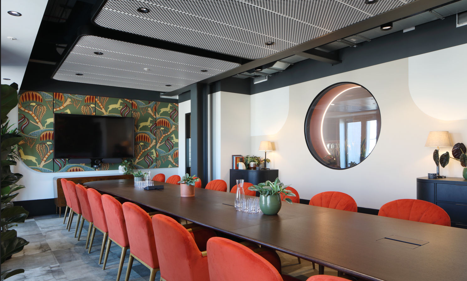 Modern meeting room with vibrant orange chairs for collaborative events at x+why The Orchard.