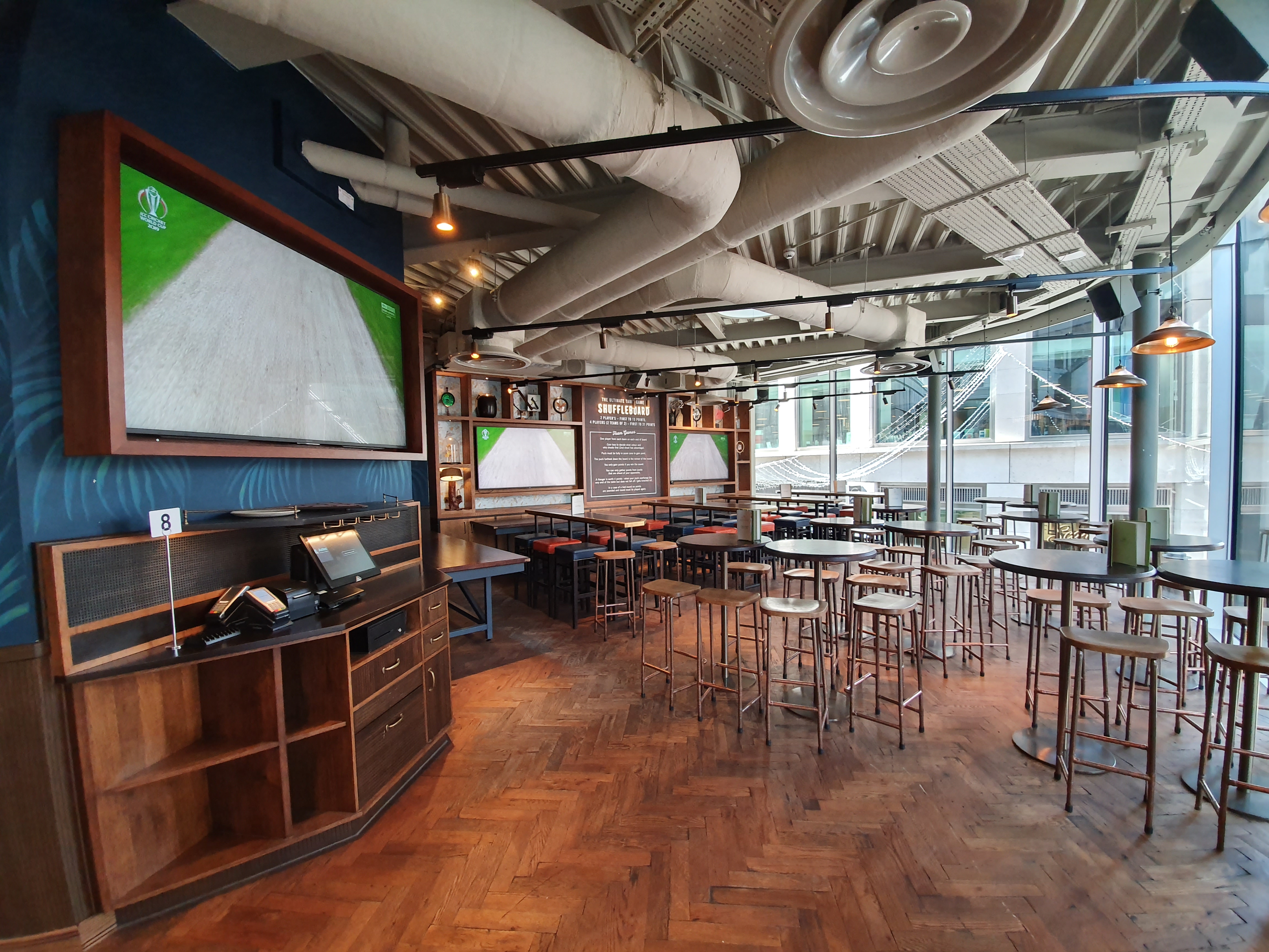 Modern event space in Broadleaf with high-top tables, perfect for networking and meetings.