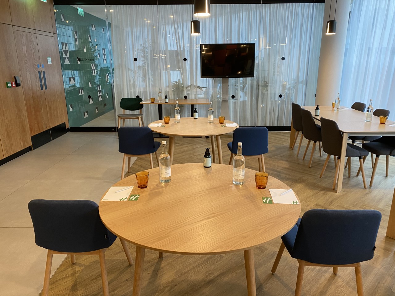 Cavell St Kitchen and Bar meeting space with round tables for corporate events in London.