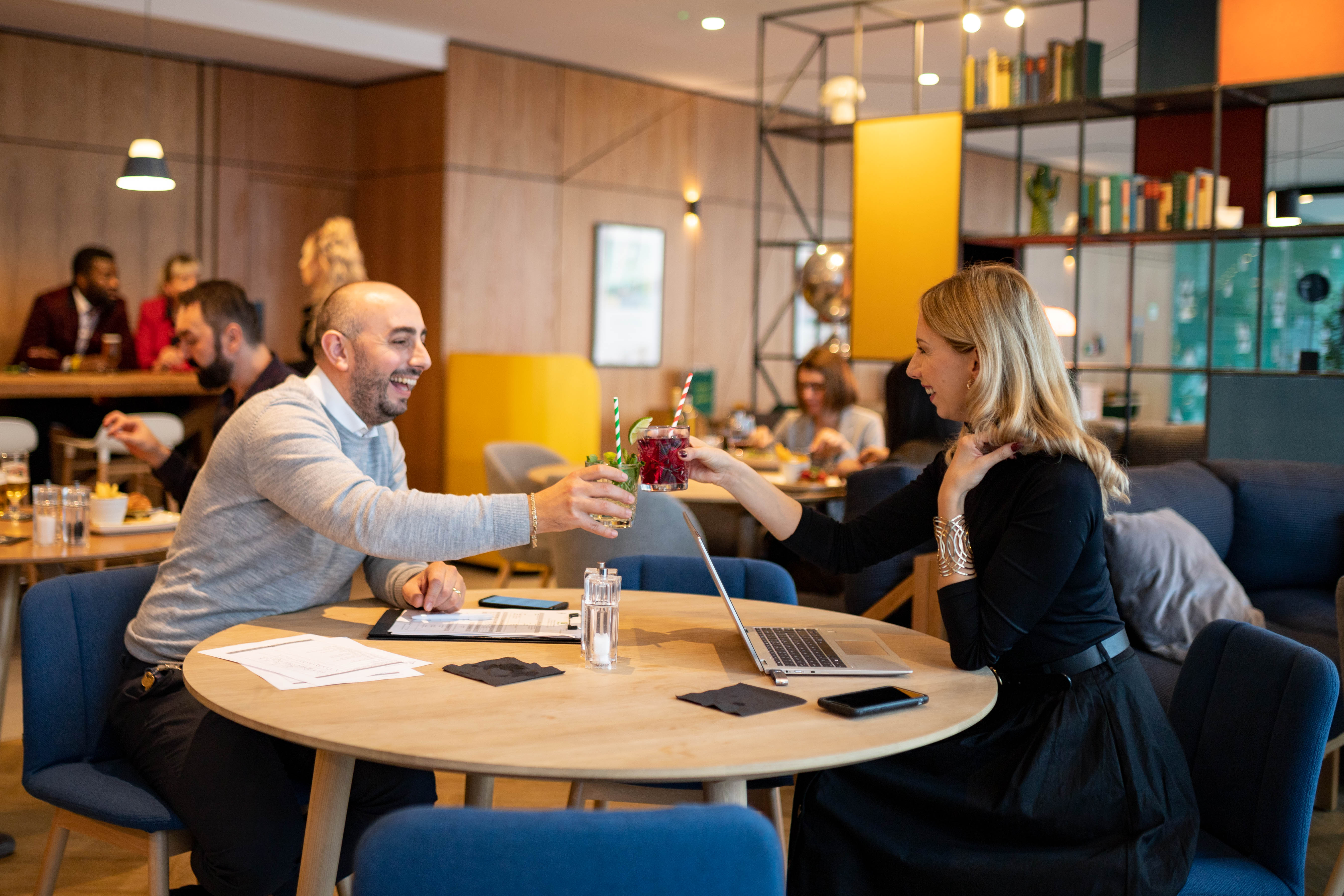 Vibrant networking event at Cavell St Kitchen, Holiday Inn Whitechapel, with professionals toasting.