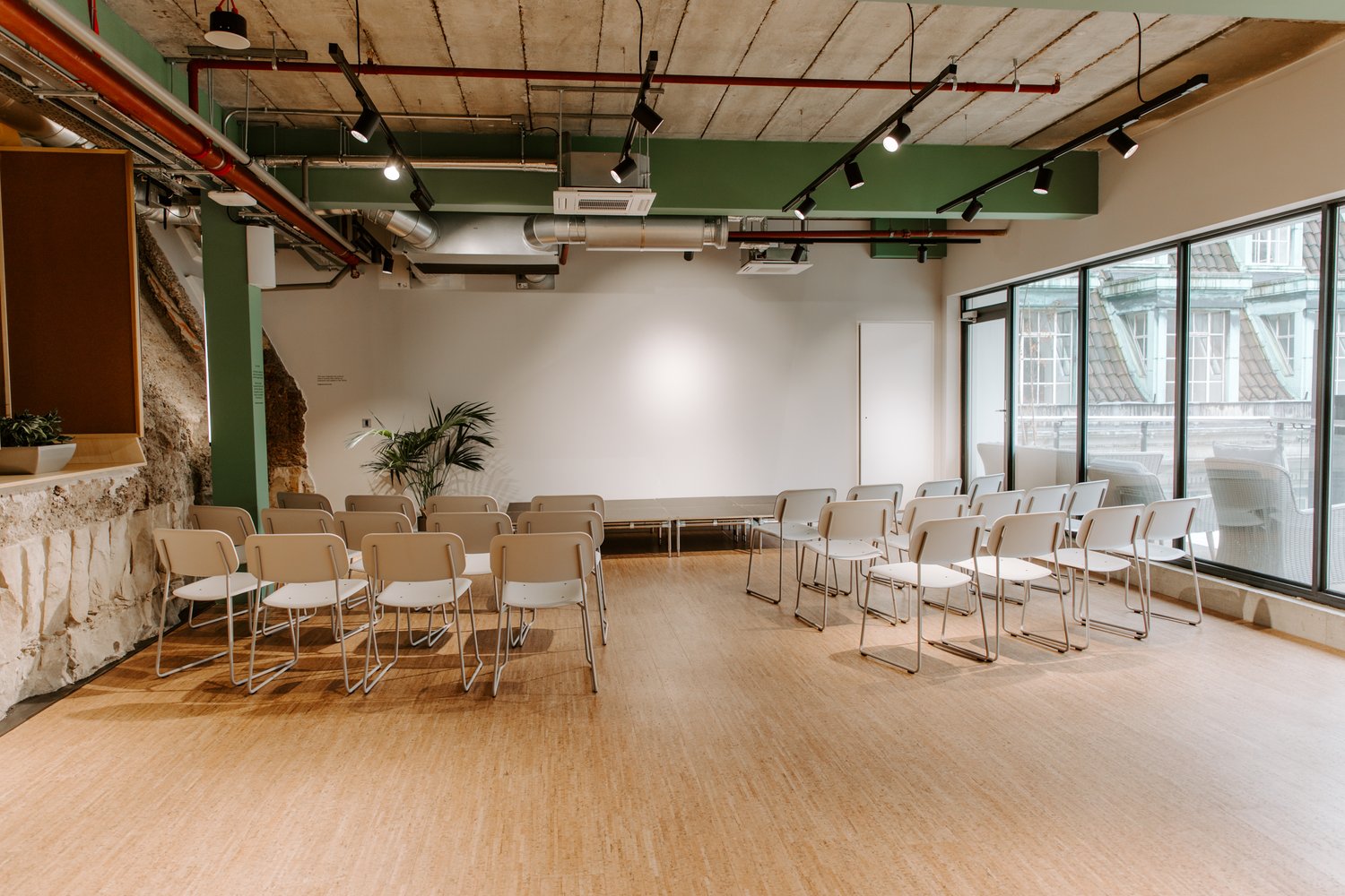 Versatile event space with natural light for workshops and corporate events.