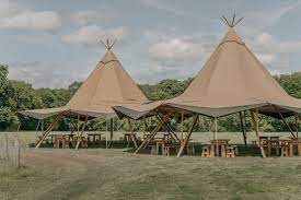 Stylish tipis in serene outdoor setting, perfect for unique events and gatherings.