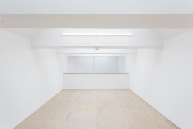 Versatile minimalist event space with natural light for workshops and meetings at Mimosa House.