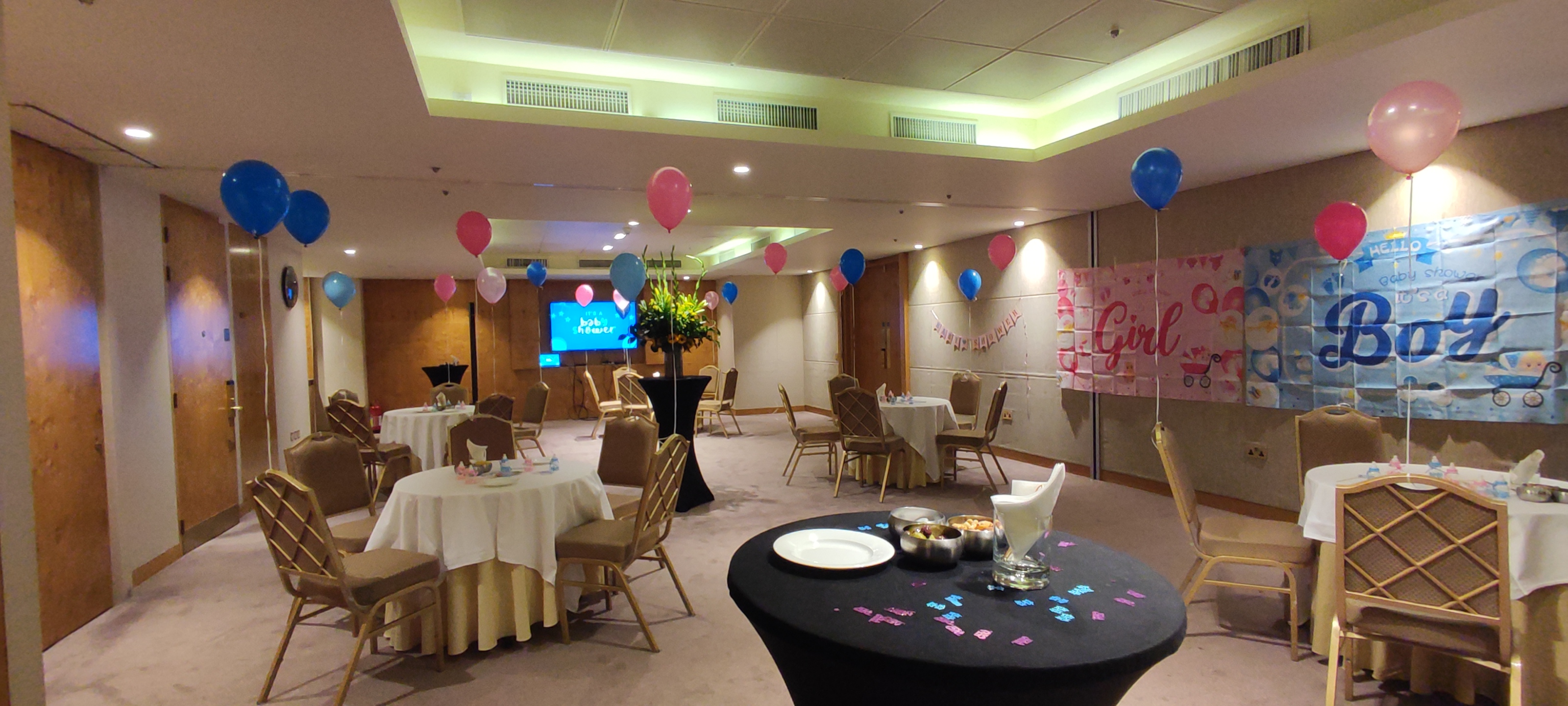 Vibrant Landmark Rooms event space with round tables for a birthday celebration.