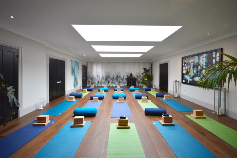 Serene yoga studio with colorful mats for wellness retreats and corporate events.